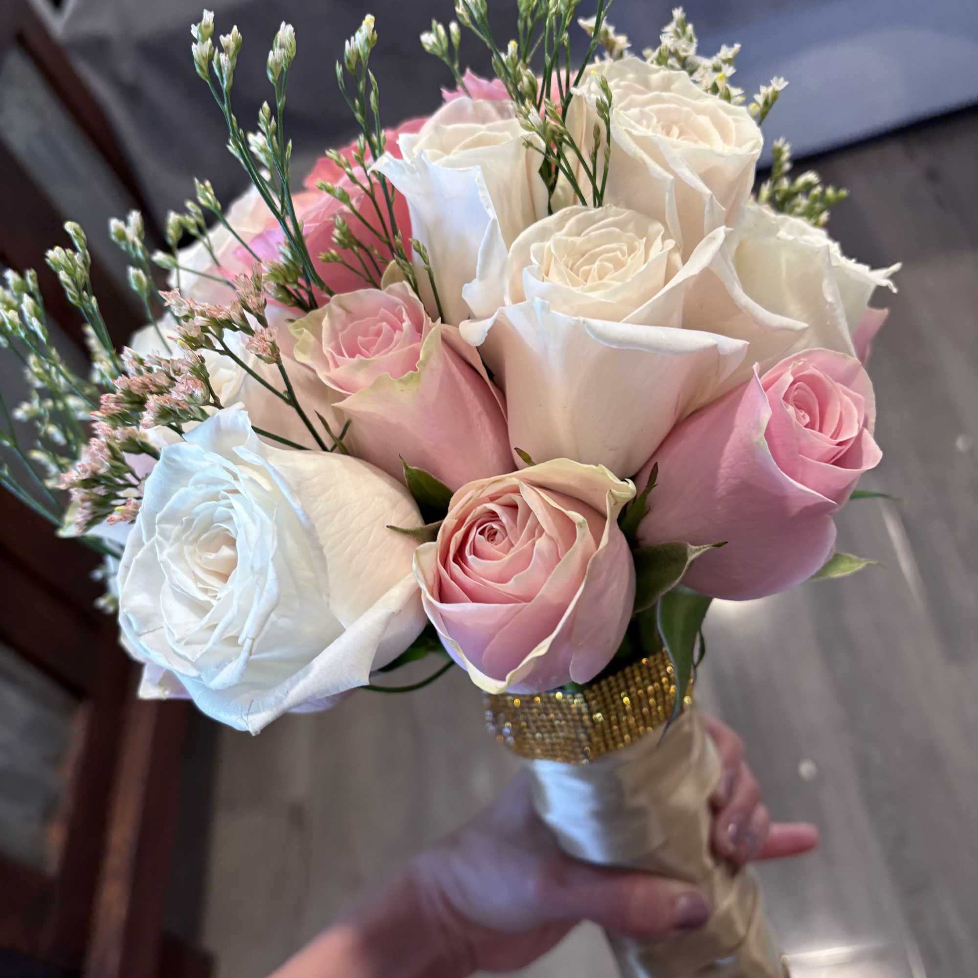 Bouquet of pink and white roses with delicate filler flowers