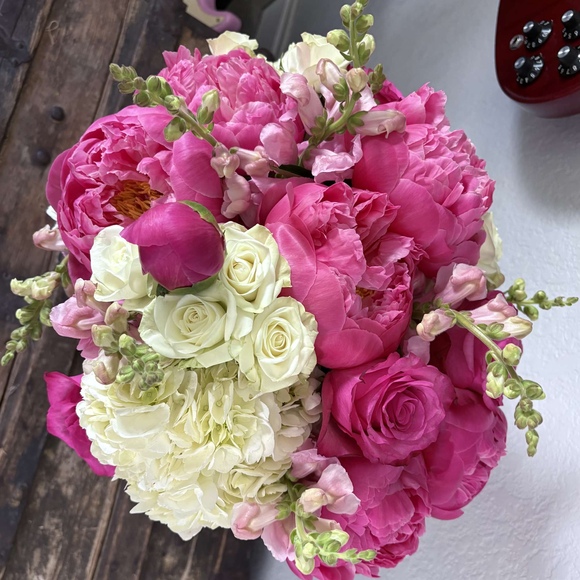 Pink peonies and white roses with pale snapdragons in a bouquet