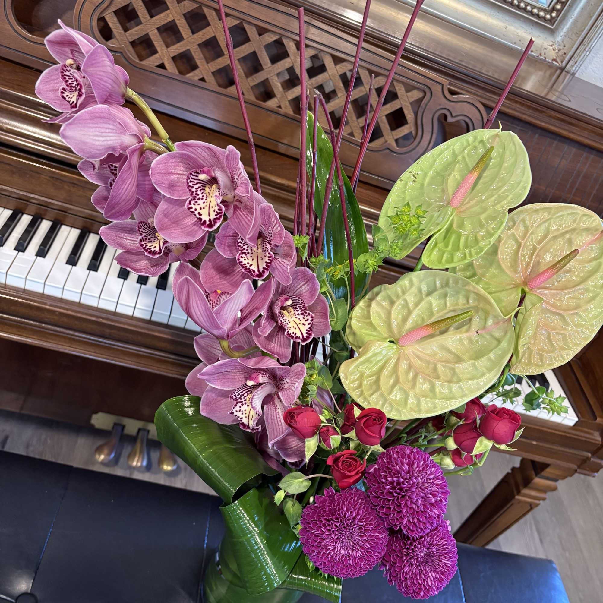 Pink orchids and magenta flowers arranged in a vase
