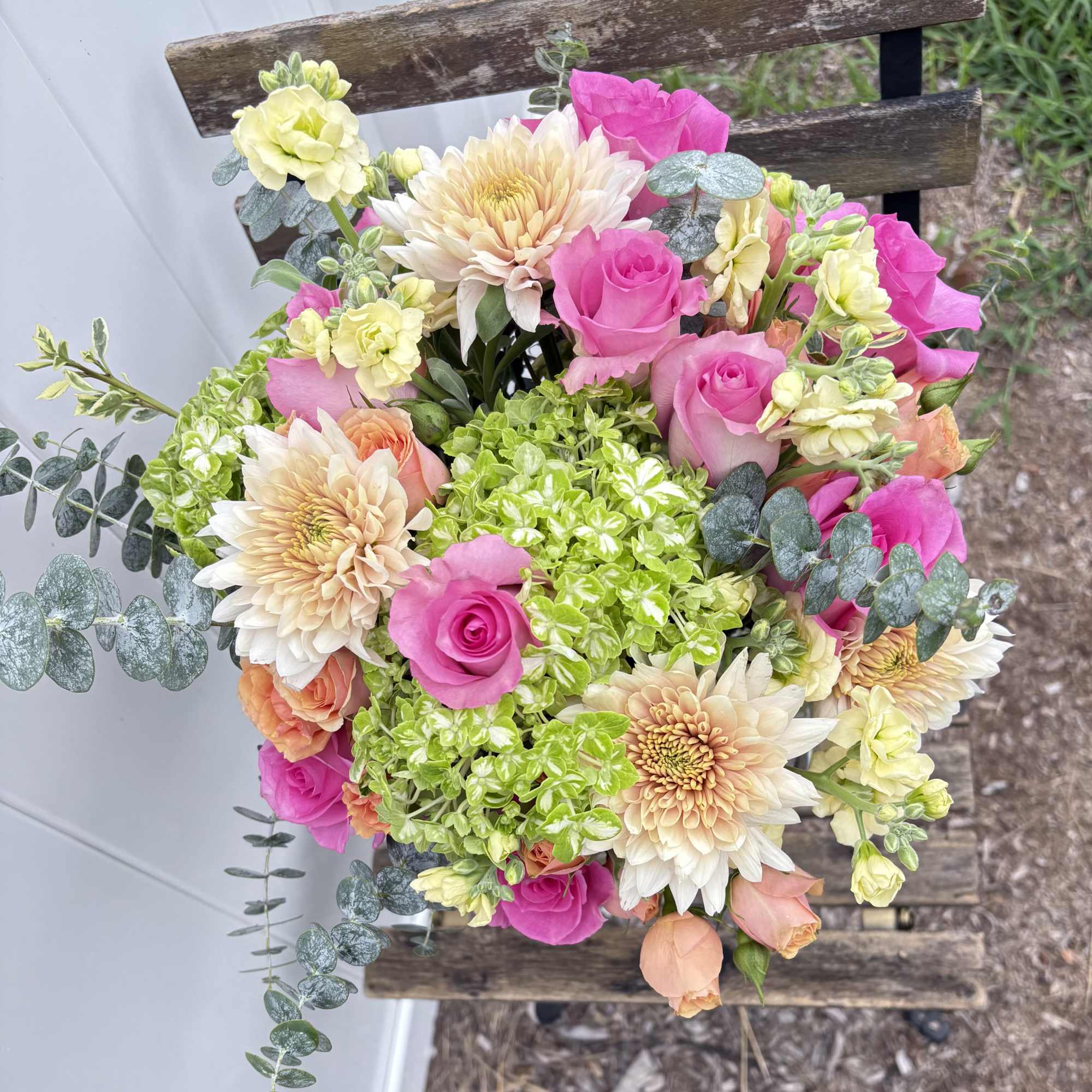 Bouquet of pink roses, cream dahlias, and green hydrangeas