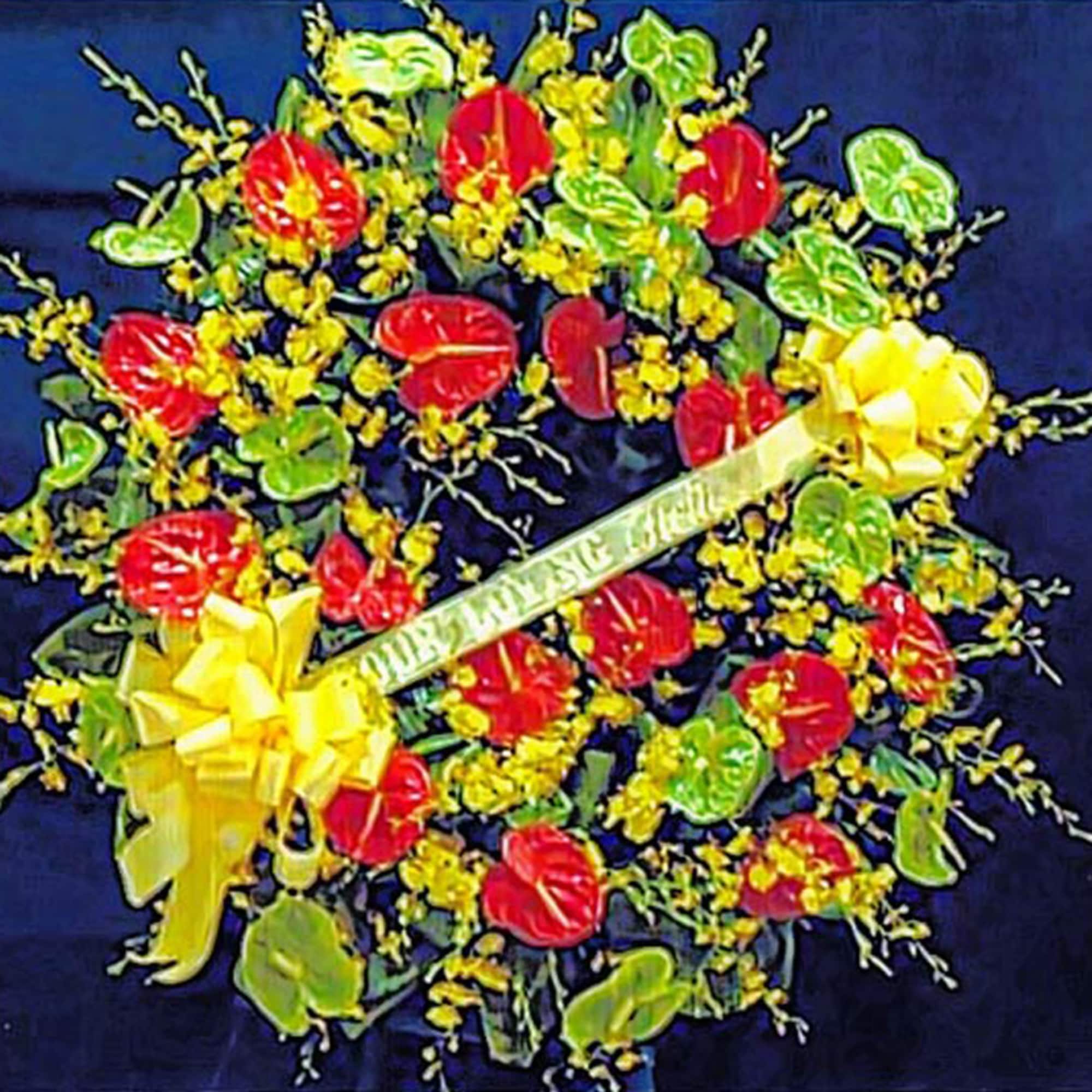 Round wreath with red and green tropical flowers and small yellow blooms with a yellow sympathy ribbon.