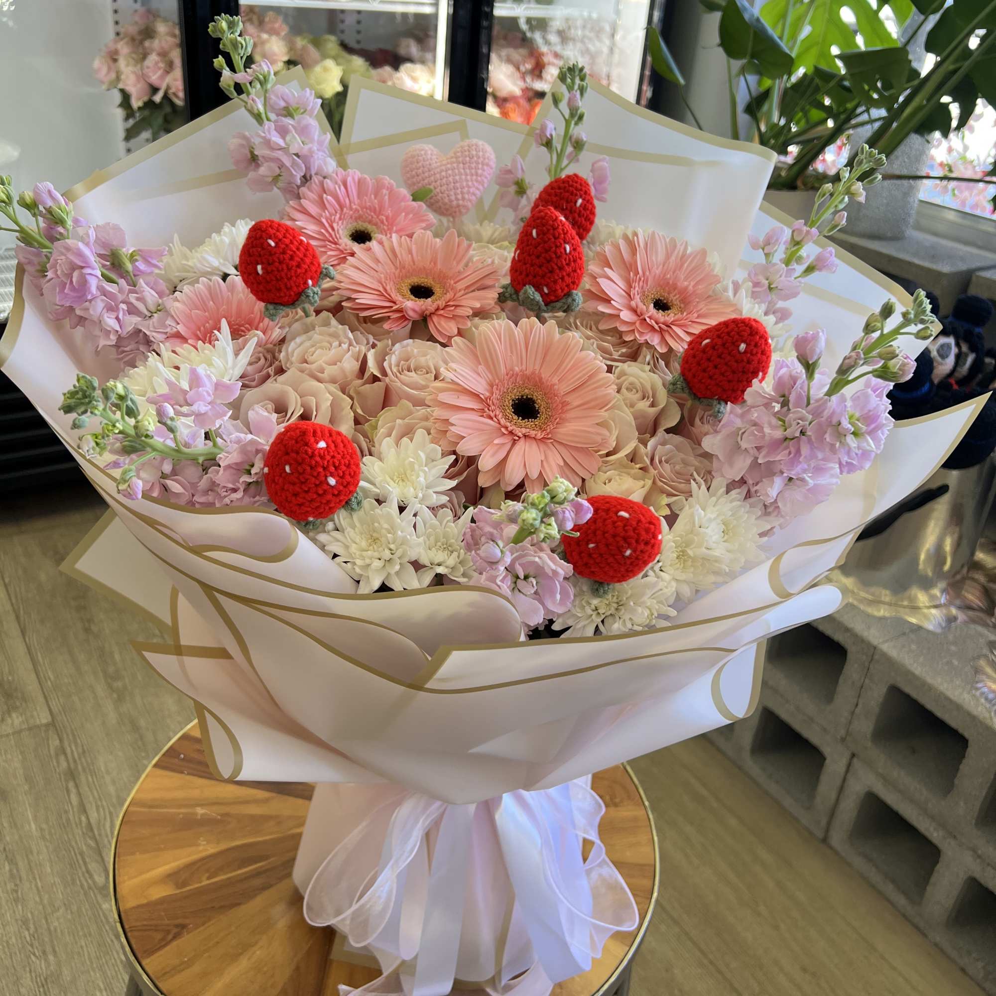 Pink and cream bouquet with gerbera daisies and crocheted strawberry accents