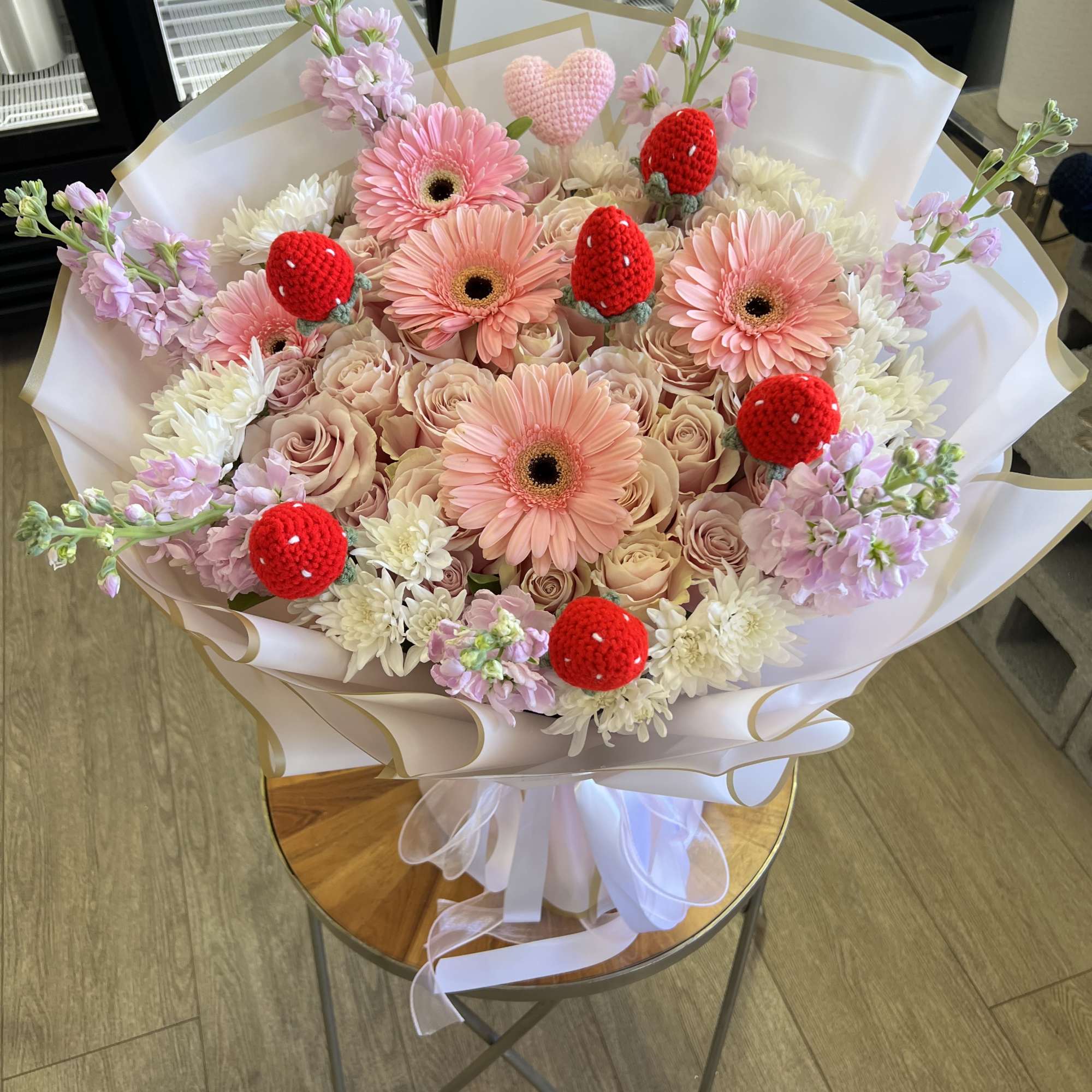 Pink gerbera and roses bouquet with red strawberry decorations