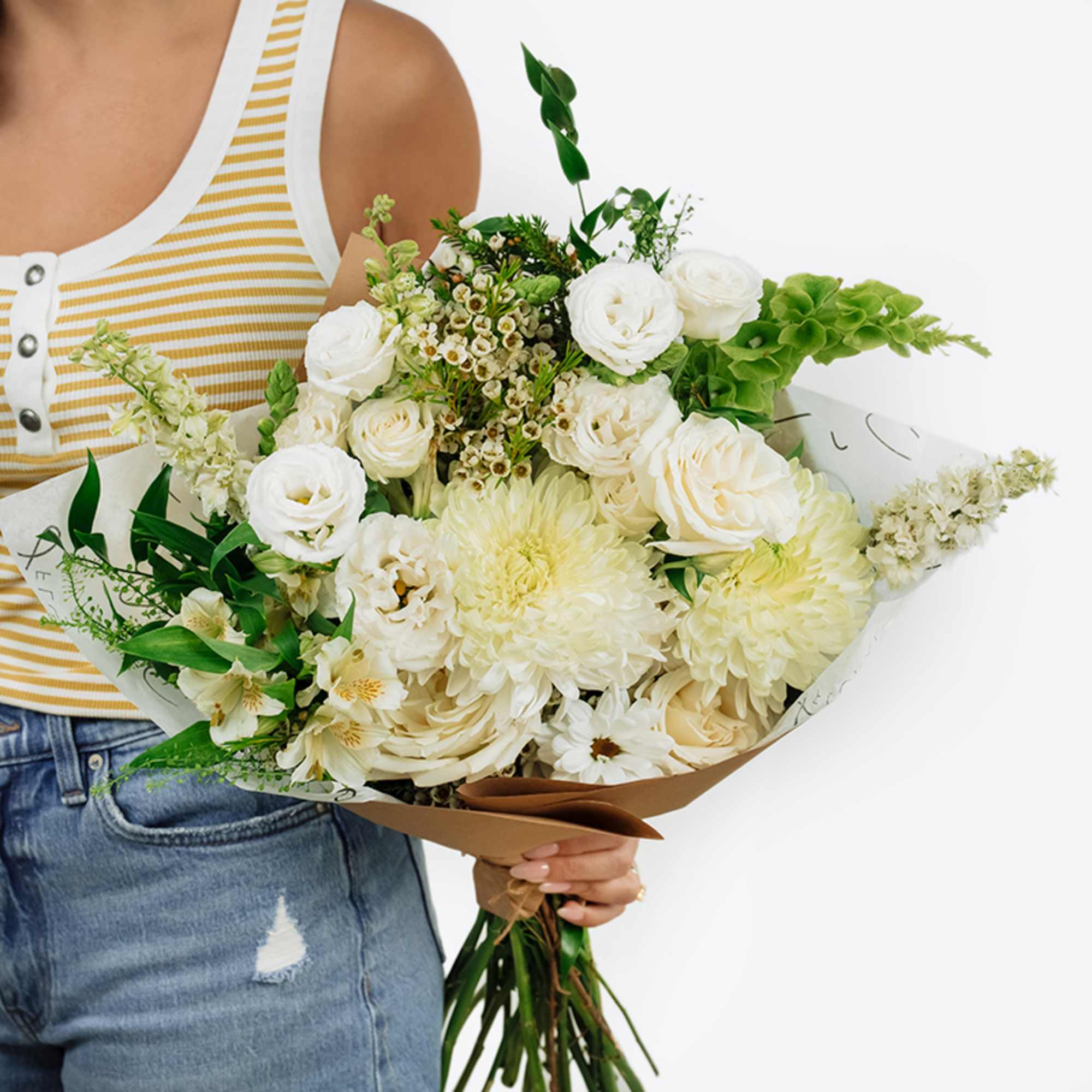 Large bouquet of white and cream flowers with green accents