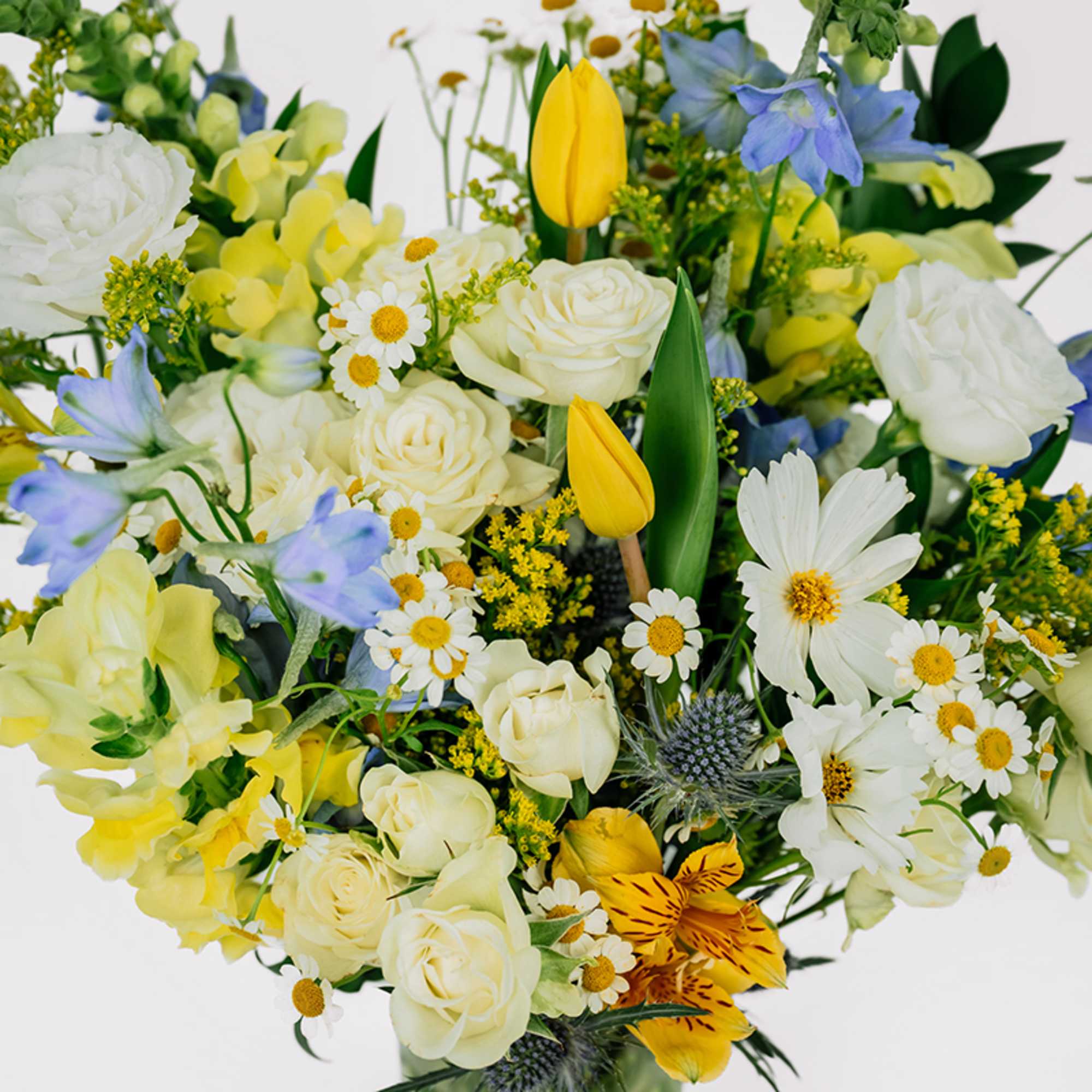 Bouquet of white and yellow flowers with blue accents