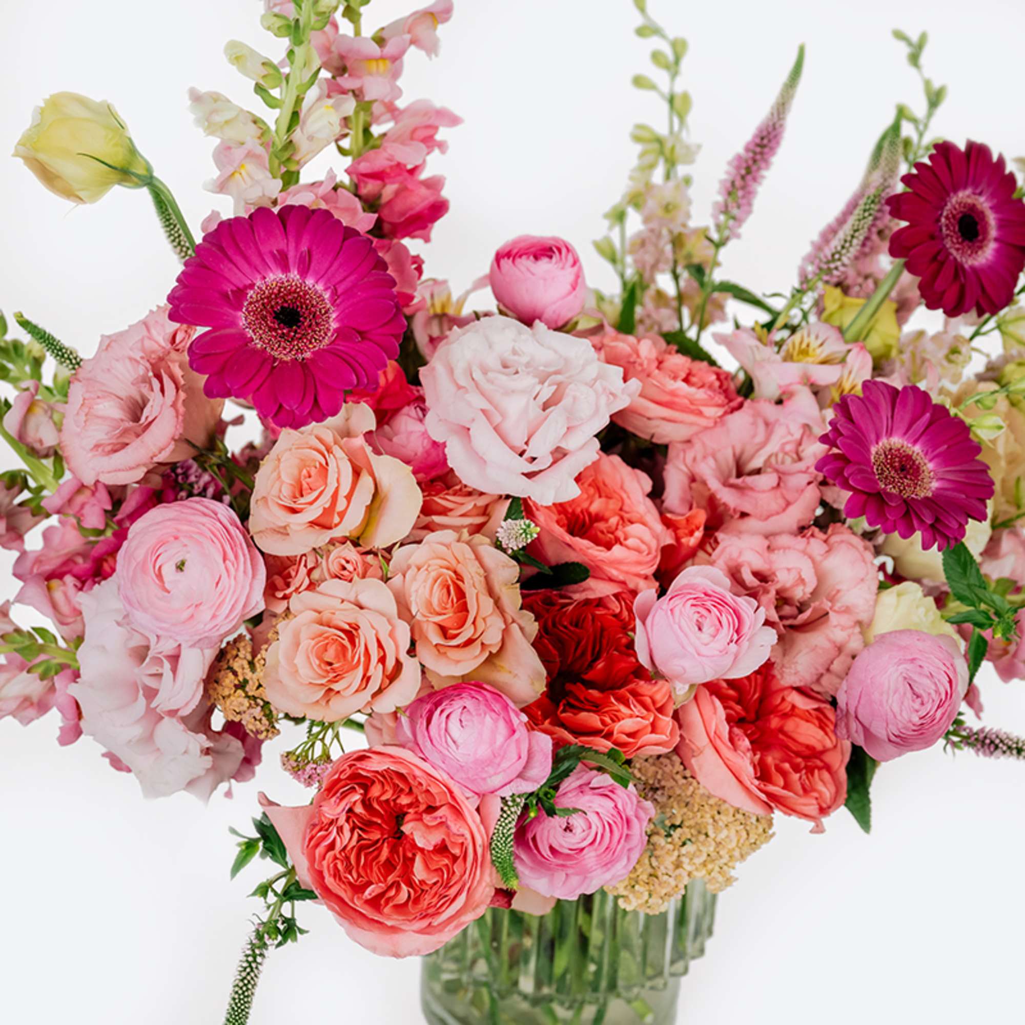 Pink and coral mixed bouquet in a glass vase