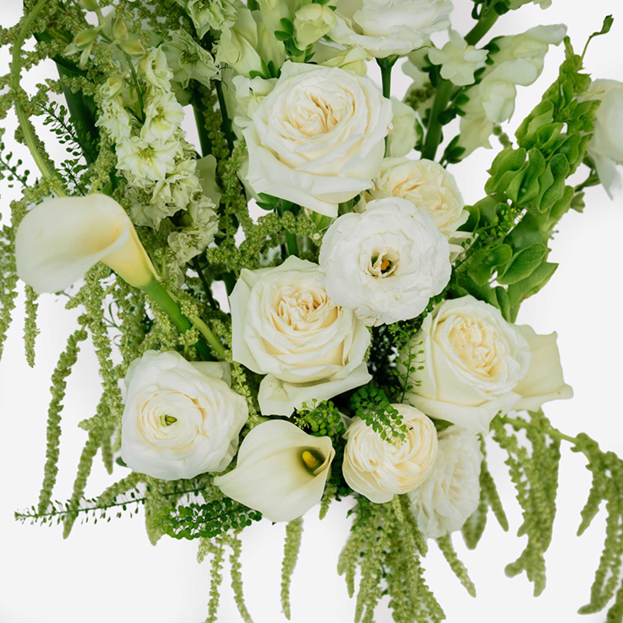 White roses and calla lilies with green trailing accents