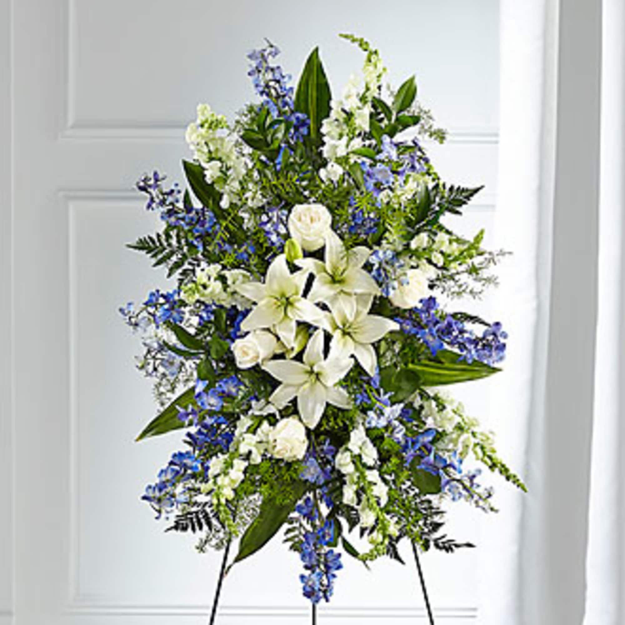 Standing floral spray with white lilies and blue flowers