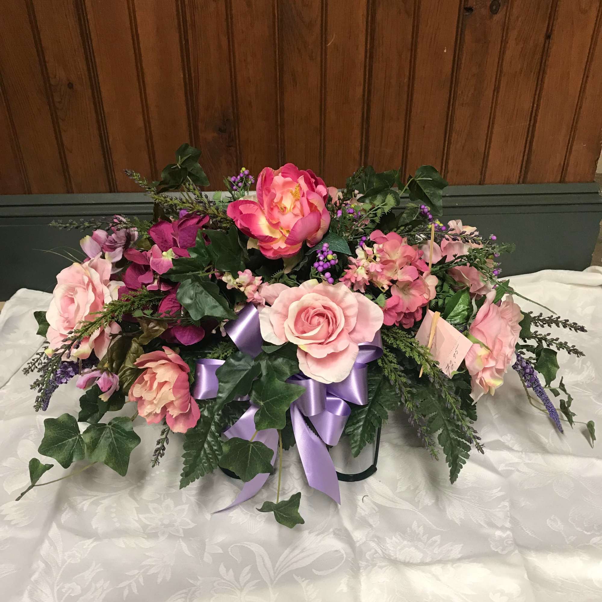 Pink and purple floral arrangement with a lavender ribbon