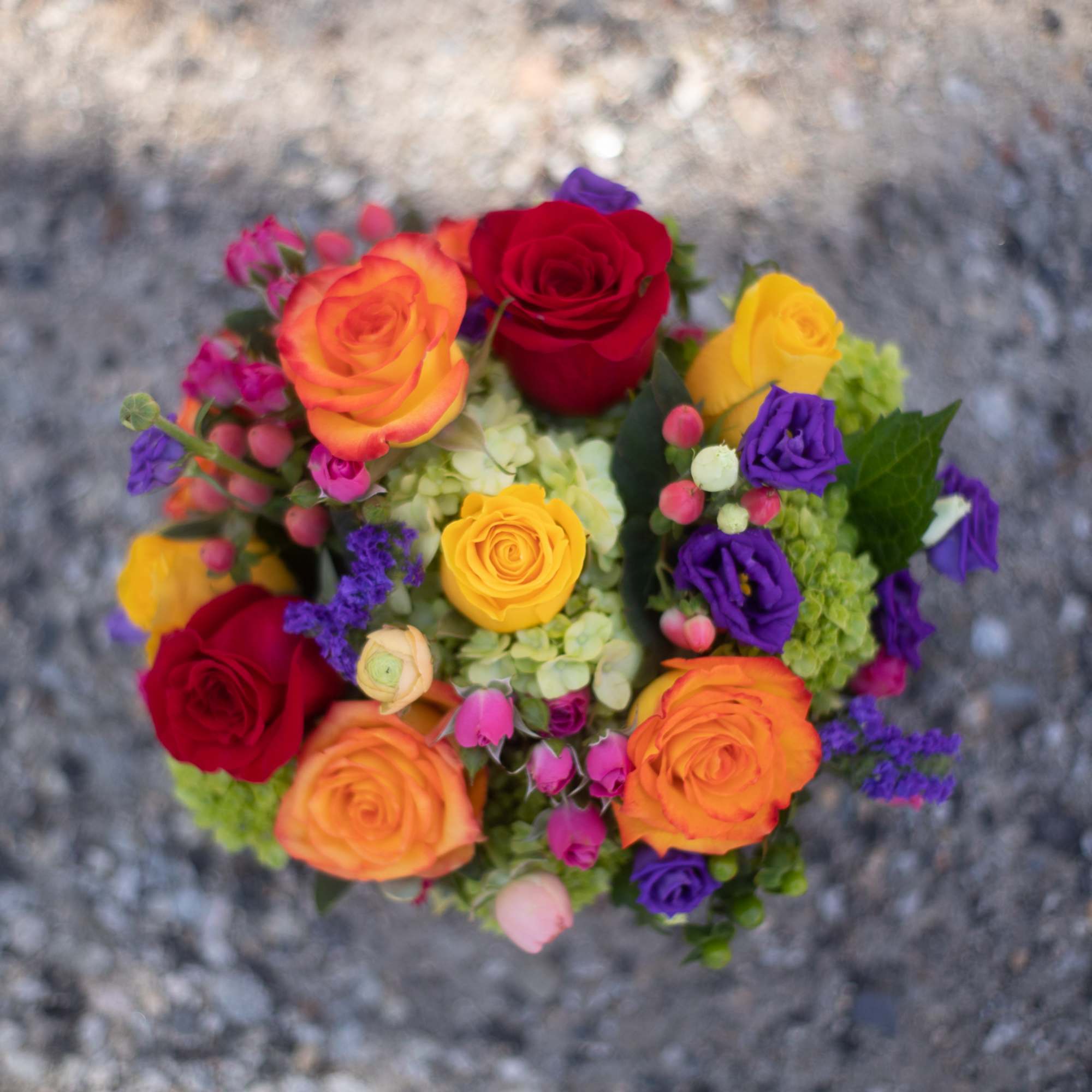 Colorful bouquet of roses and small purple flowers