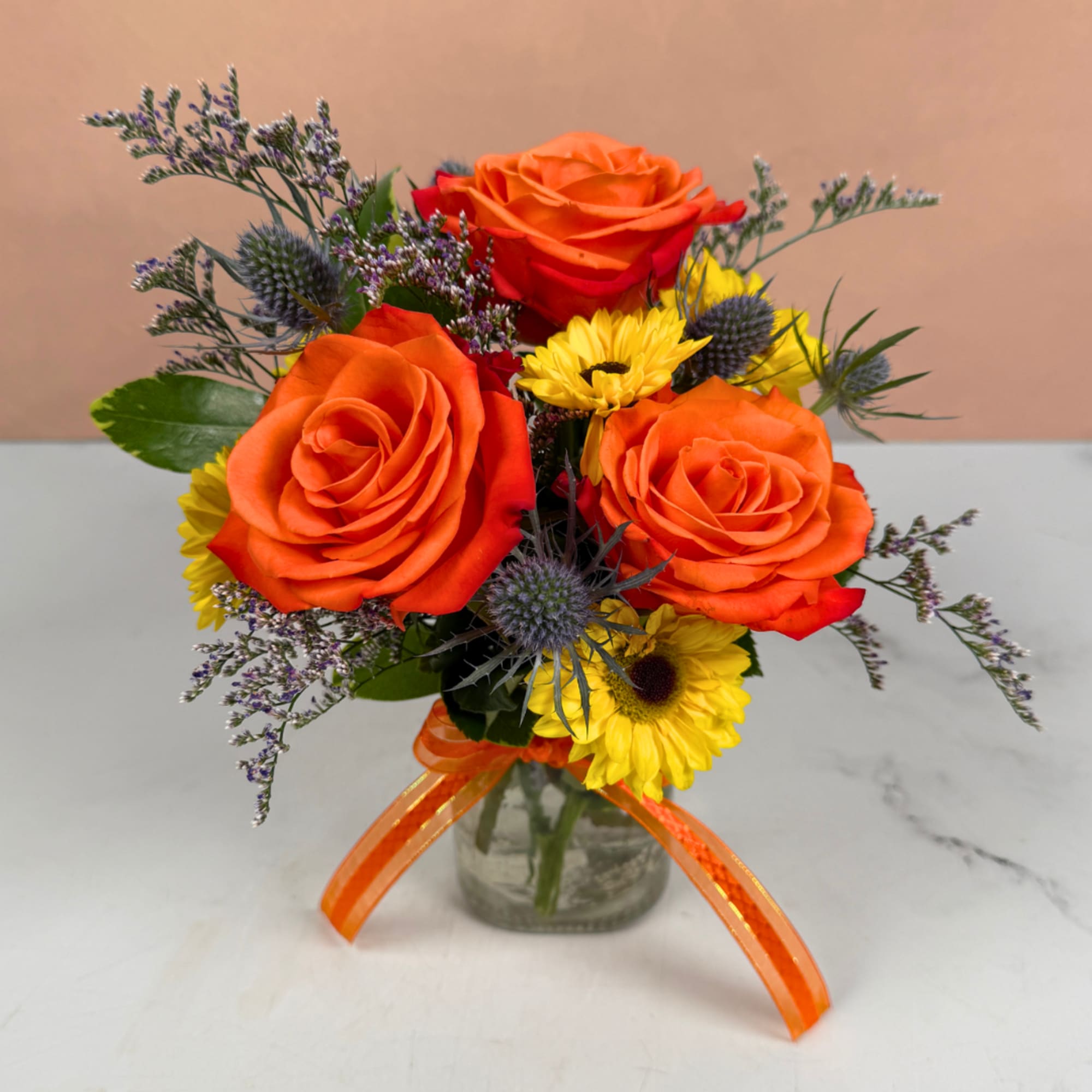 Orange roses and yellow daisies in a glass vase with an orange ribbon, photo 2 of 3
