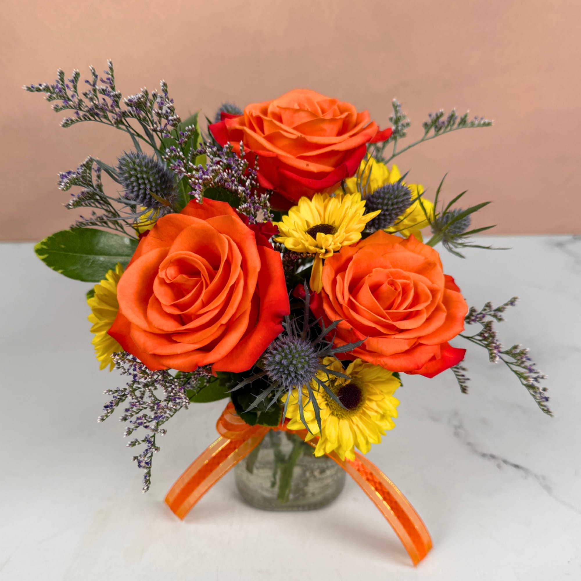 Orange roses and yellow daisies in a glass vase with an orange ribbon, photo 3 of 3
