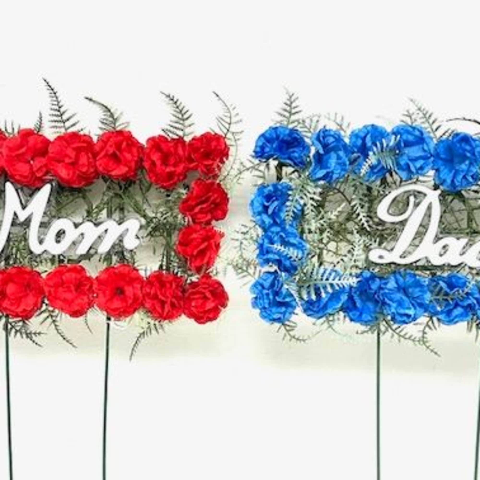 Two floral signs reading Mom and Dad made of red and blue flowers