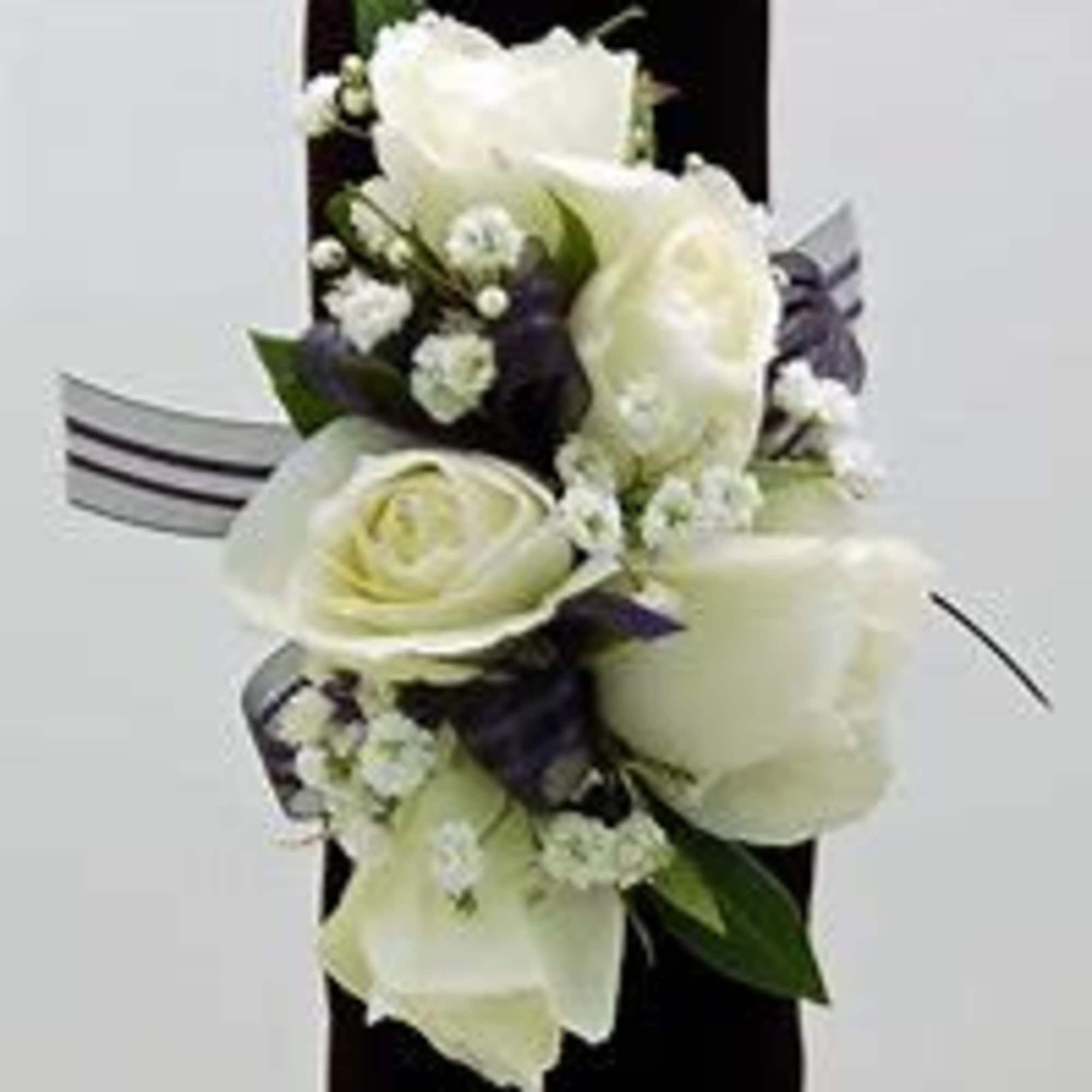 White floral corsage with ribbon on a dark band