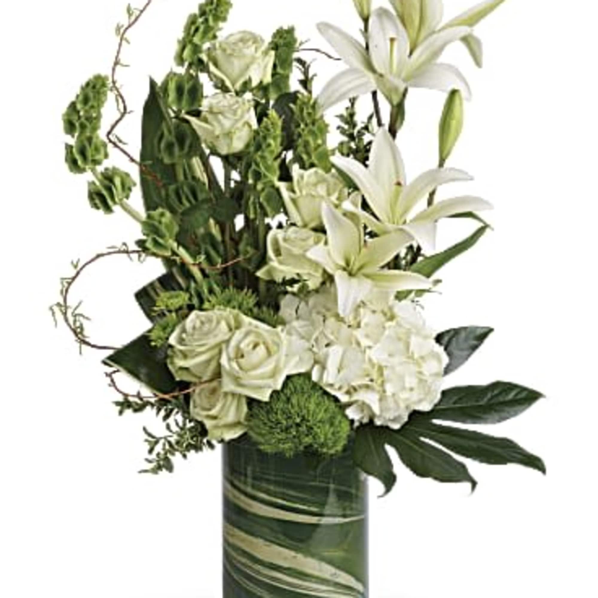 White lilies and roses arranged in a green glass vase
