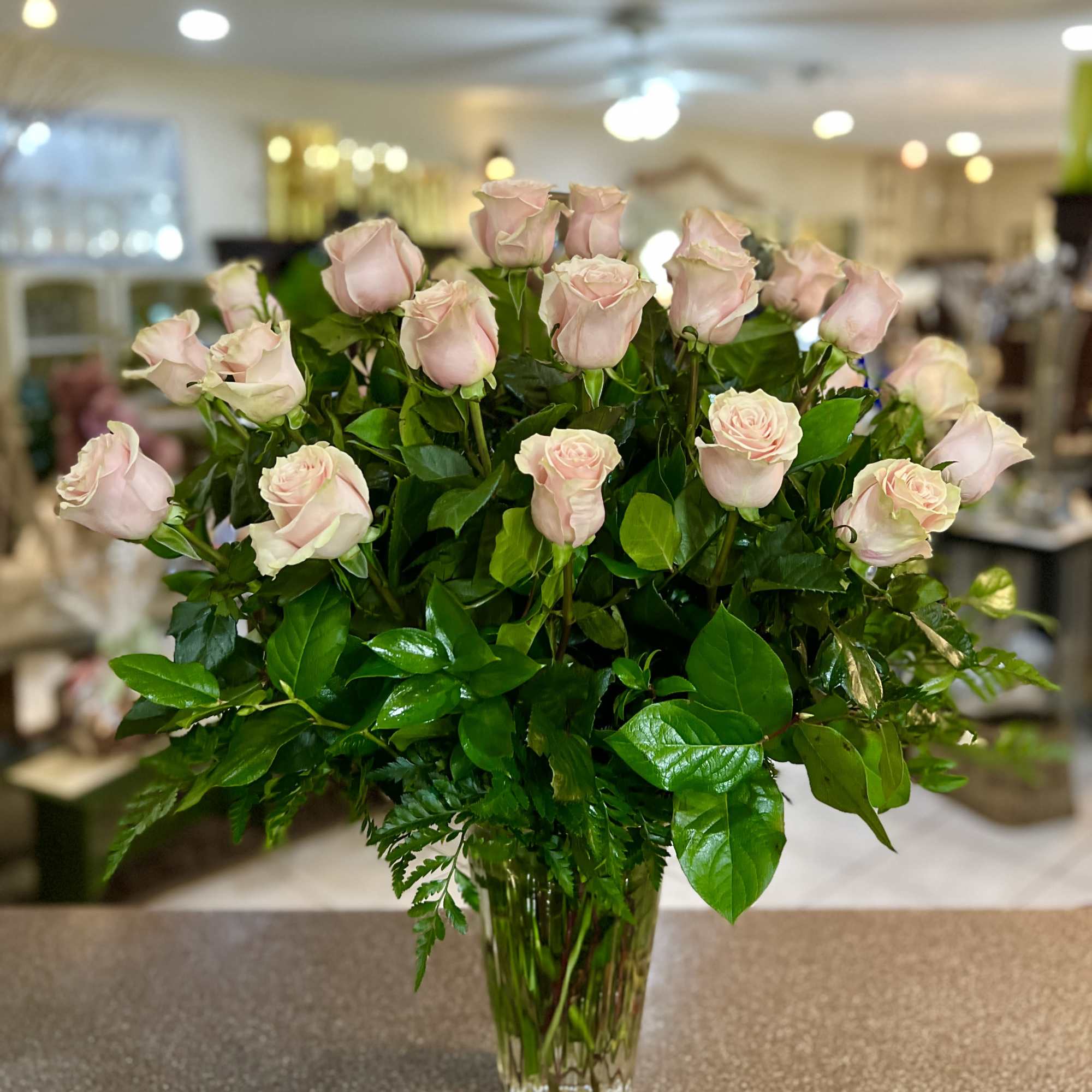 Bouquet of pale pink roses in a clear glass vase