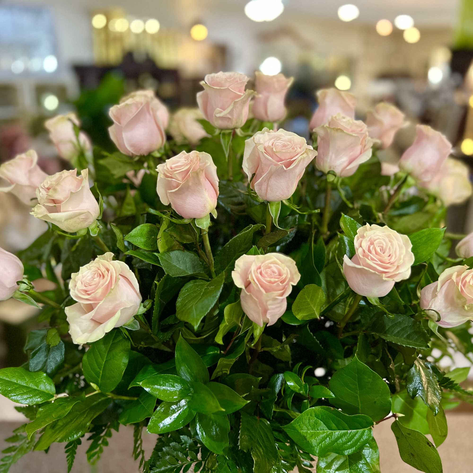 Bouquet of pale pink roses with green foliage