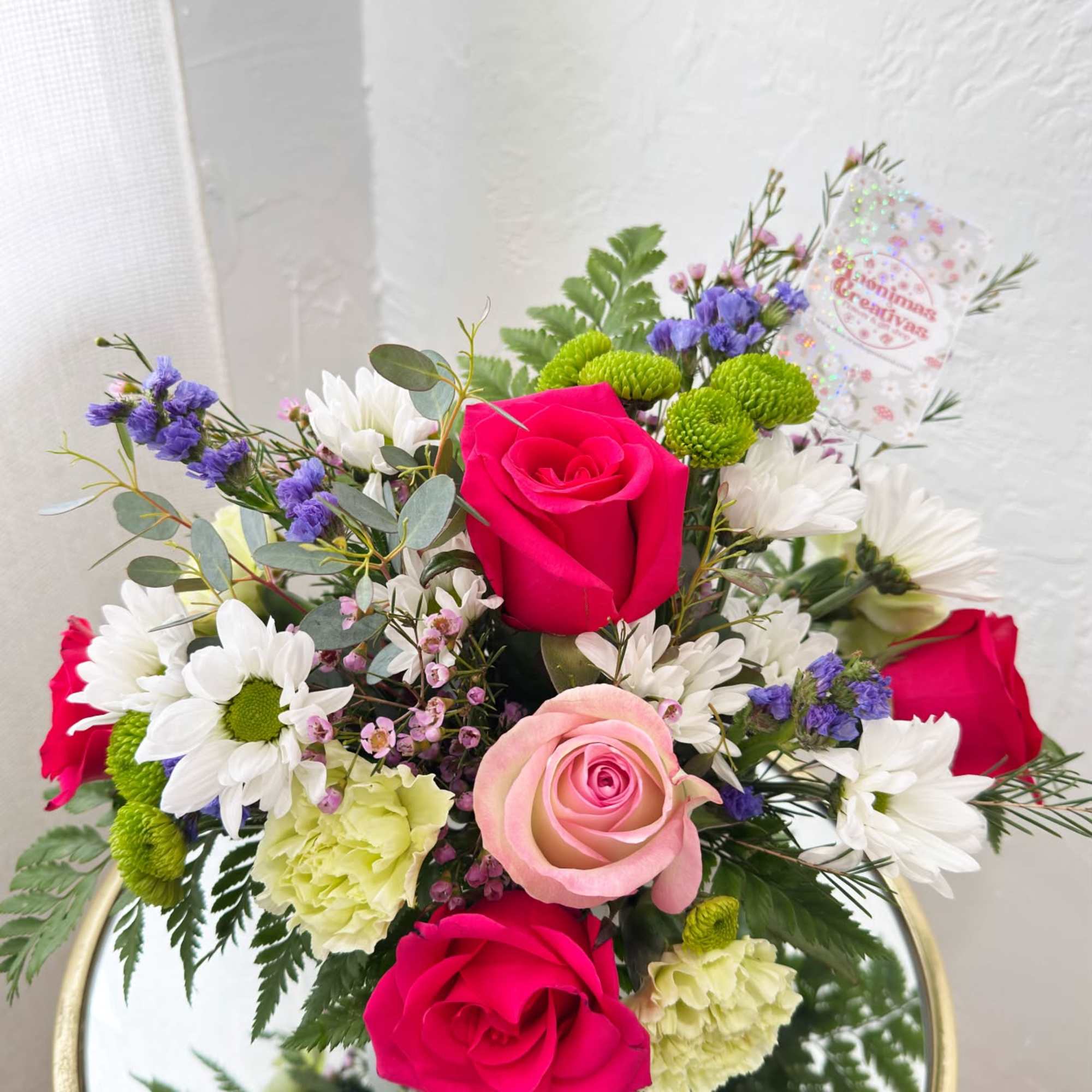 Bouquet of pink and white roses with daisies in a vase