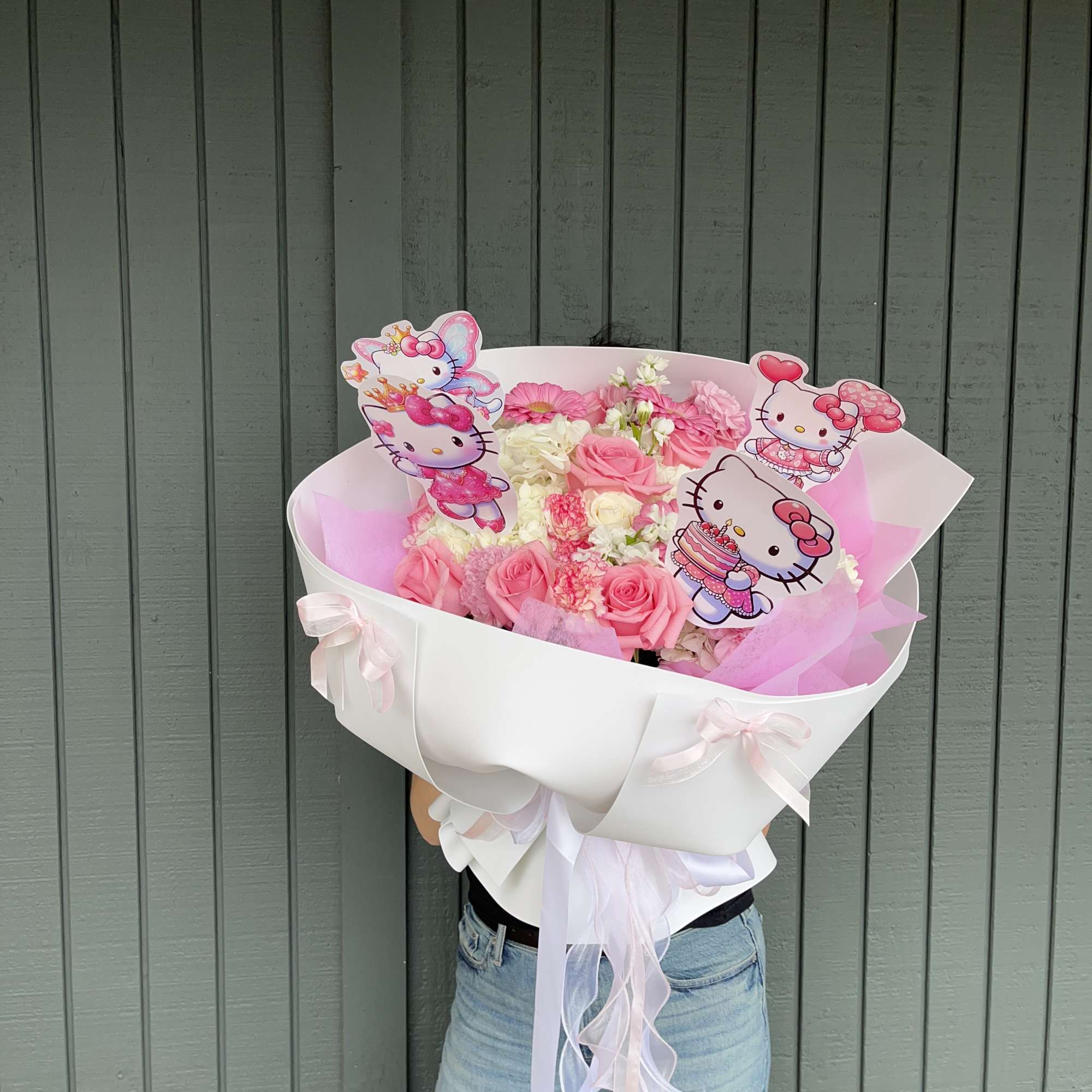 Pink and white bouquet with Hello Kitty toppers in a white wrap