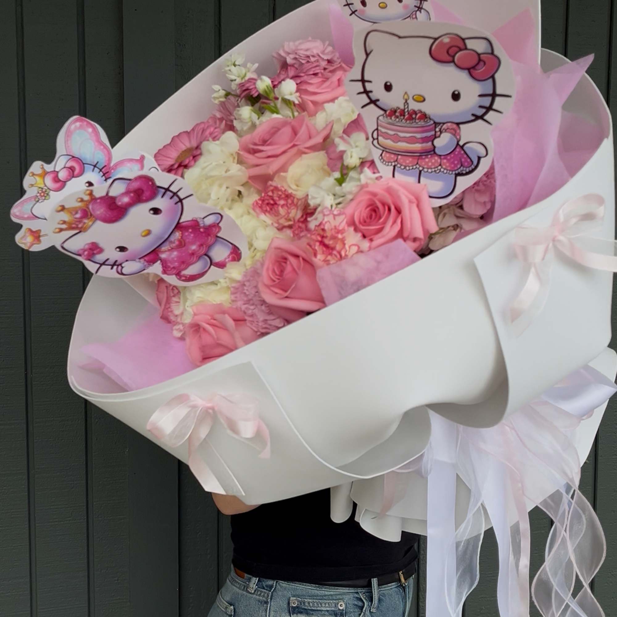Pink and white bouquet with Hello Kitty toppers and ribbon wrap