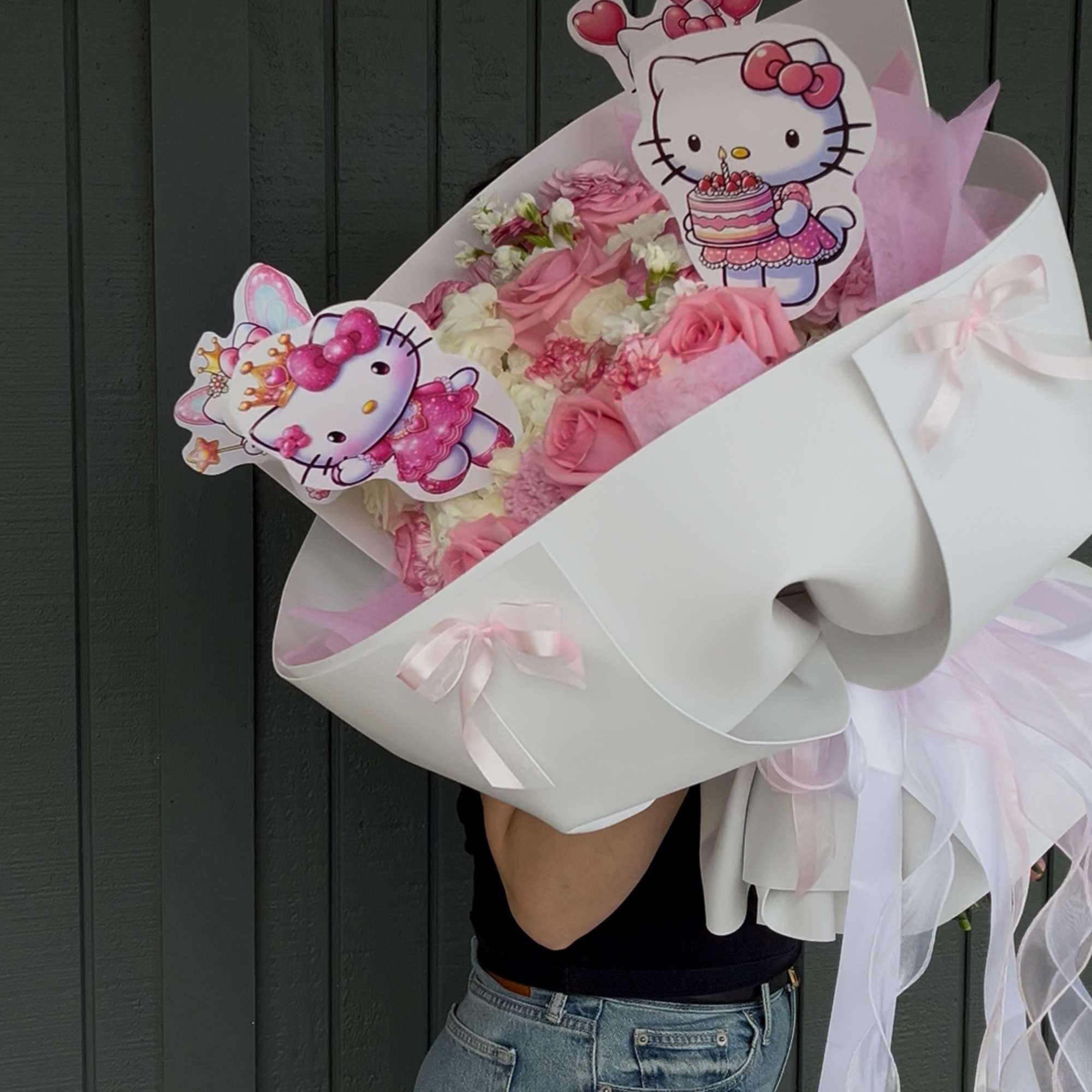 Pink rose bouquet with Hello Kitty toppers and white wrapping