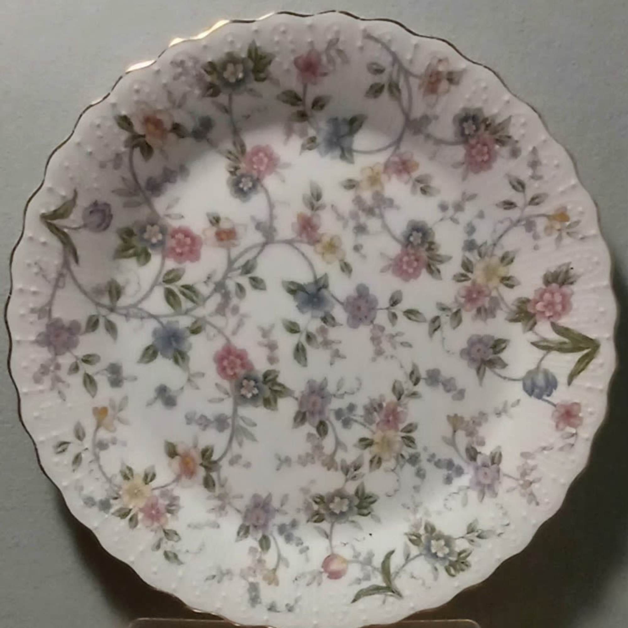 Decorative white scalloped plate with pastel floral pattern