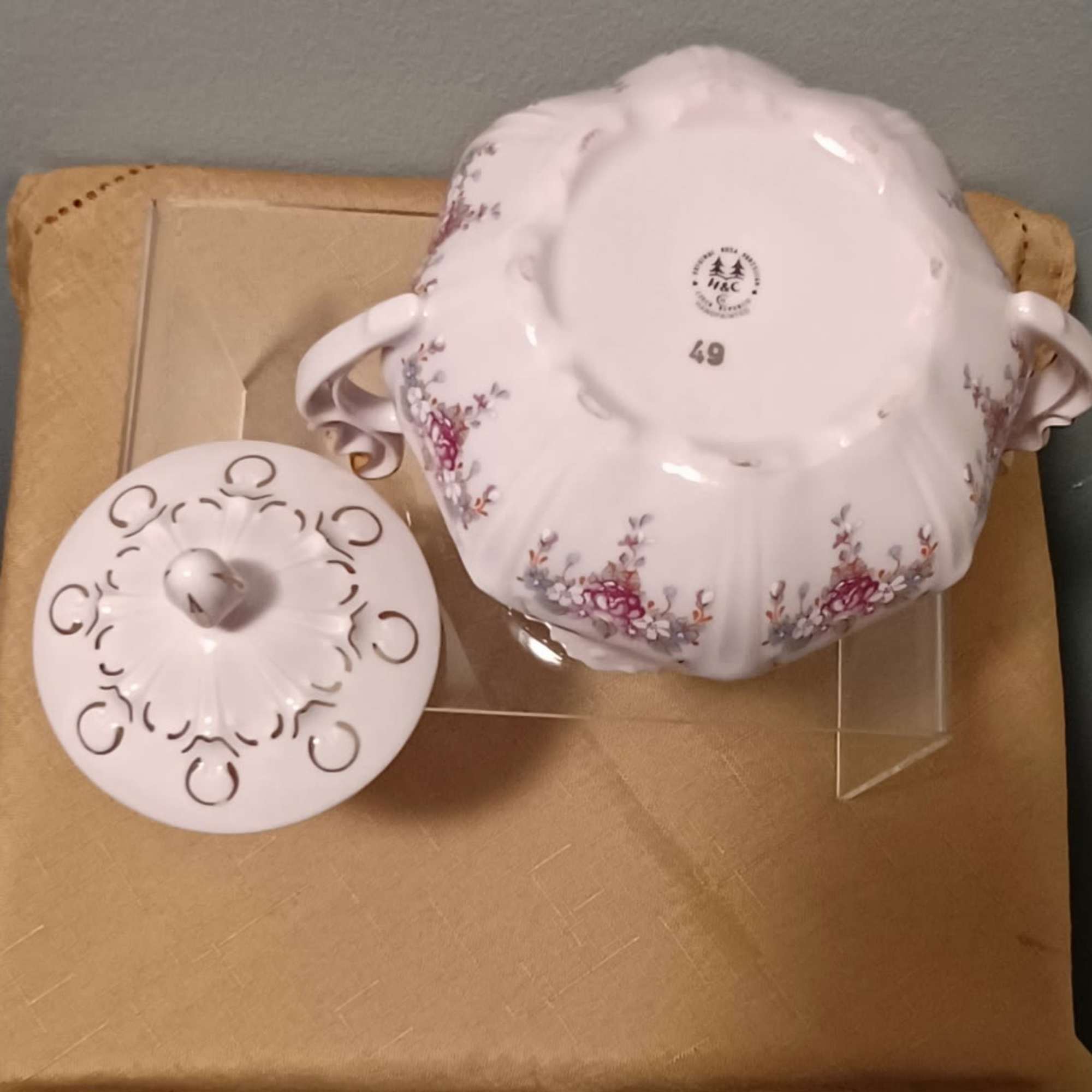 Pink floral porcelain serving bowl with matching lid on a cardboard box