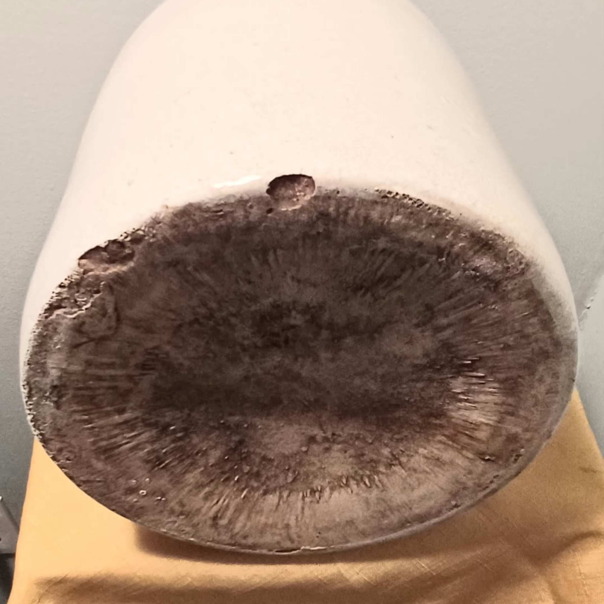 White ceramic pot with a dark, empty base opening