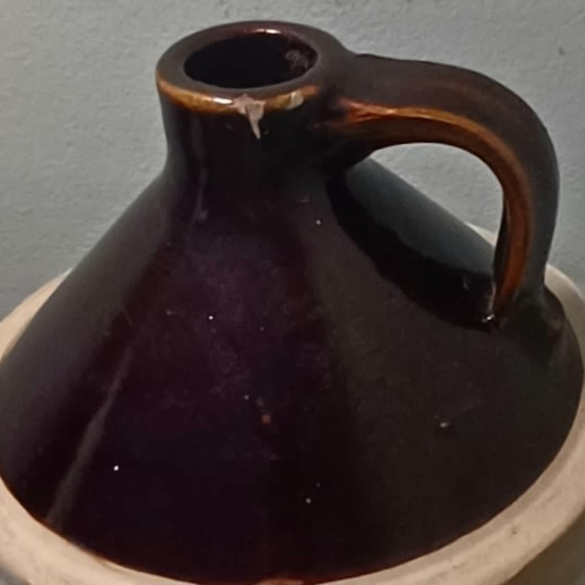 Dark brown ceramic jug-style vase with a handle