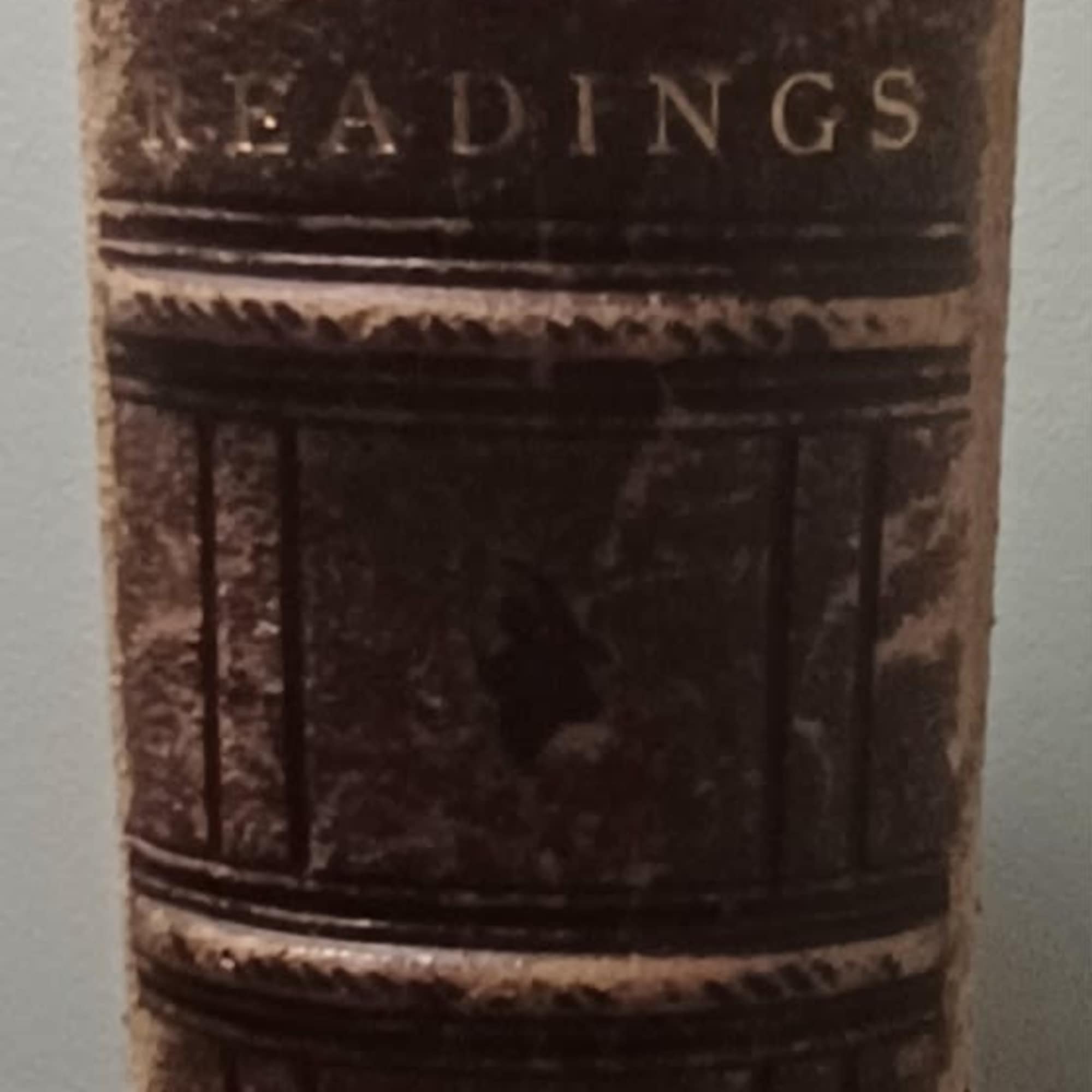 A stack of old leather-bound books standing upright