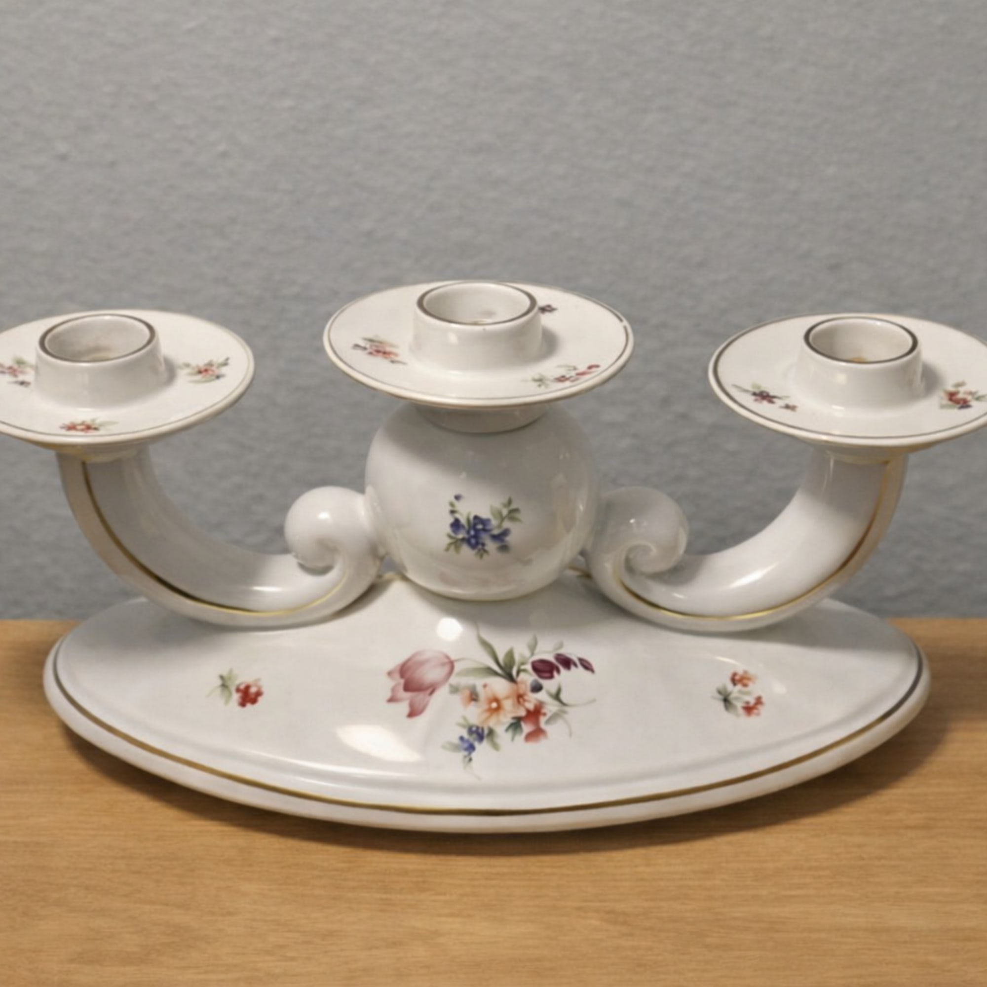 White porcelain three-arm candle holder with small floral decals