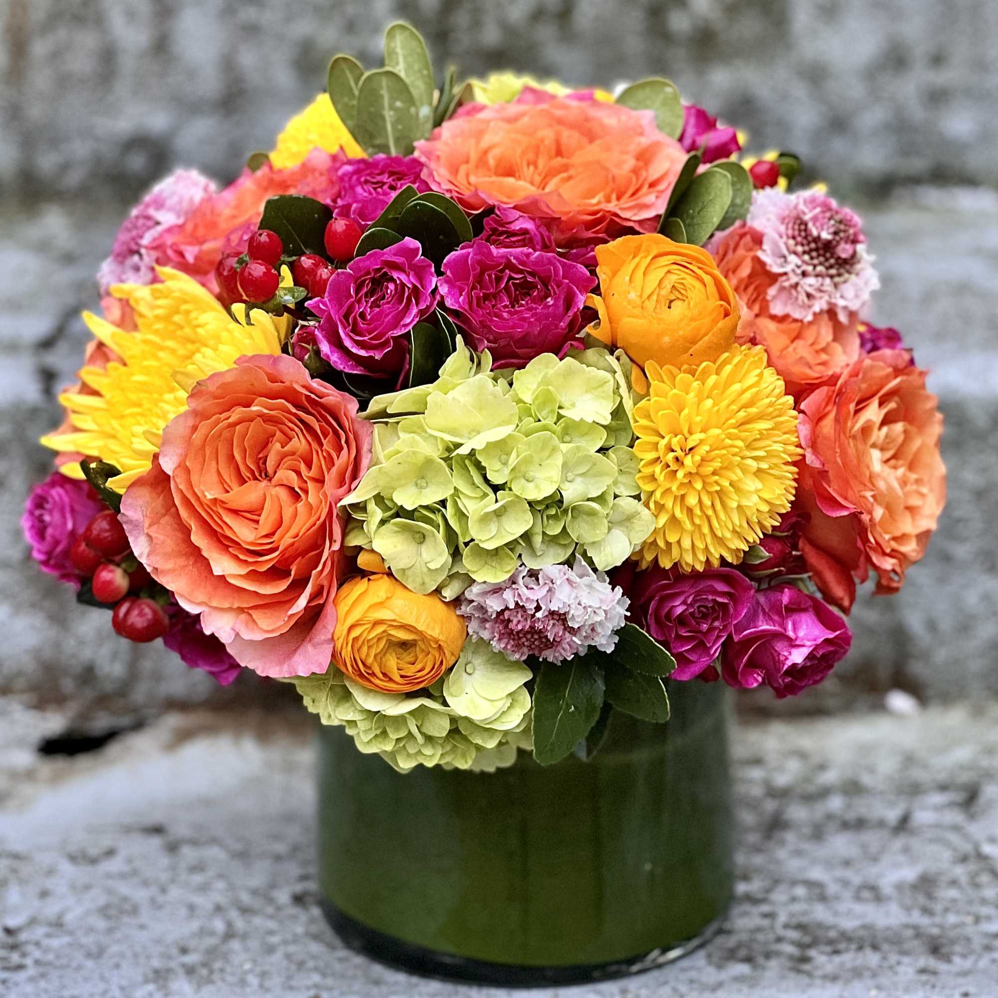 Colorful mixed bouquet in a green glass vase