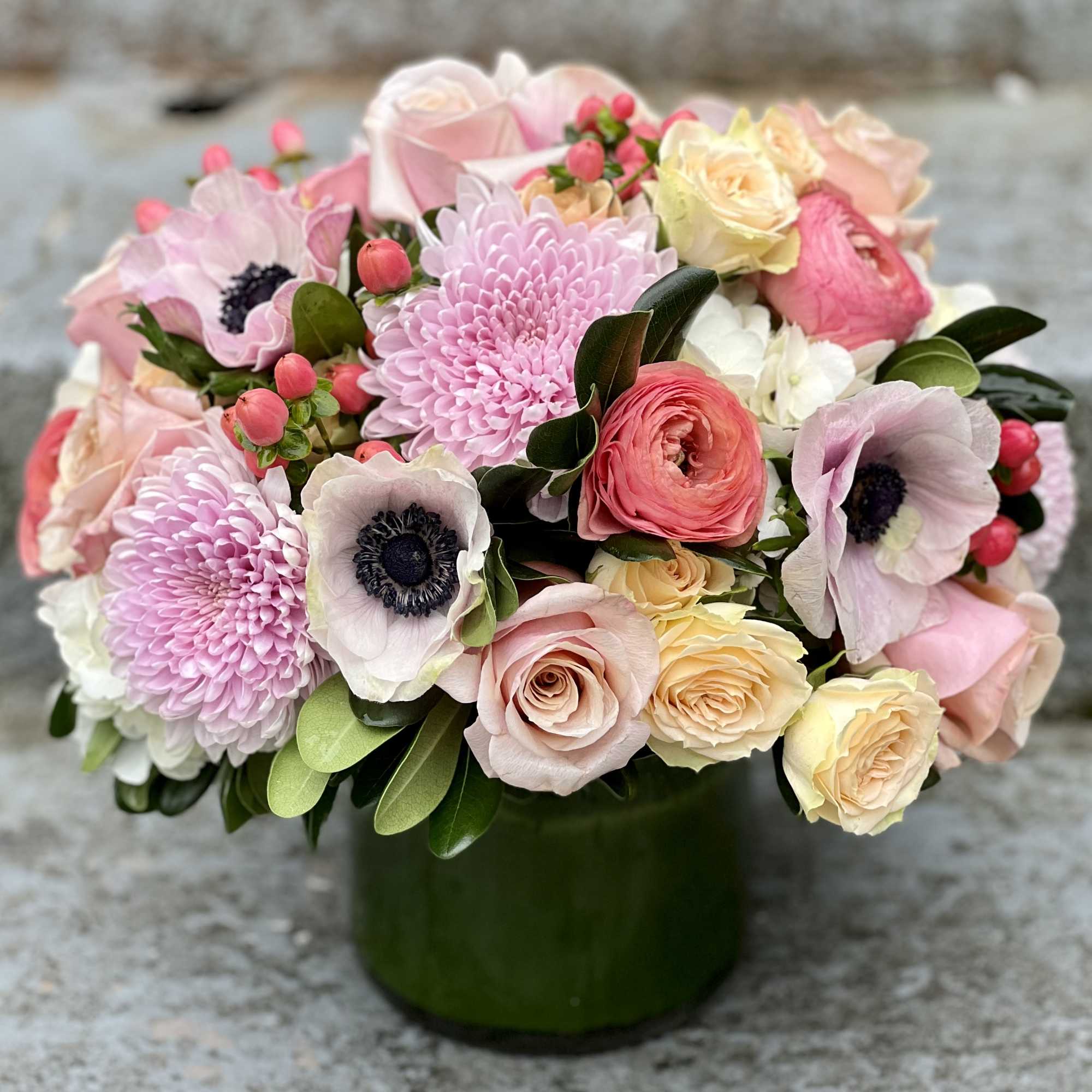 Pink and cream bouquet in a green vase