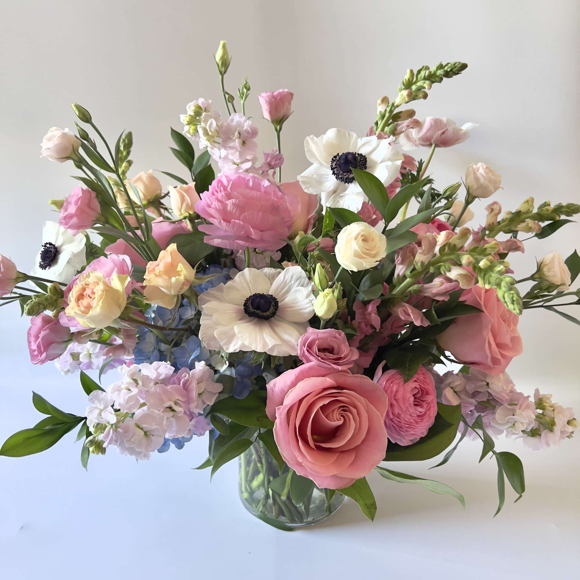 Pink and white mixed flower bouquet in a glass vase