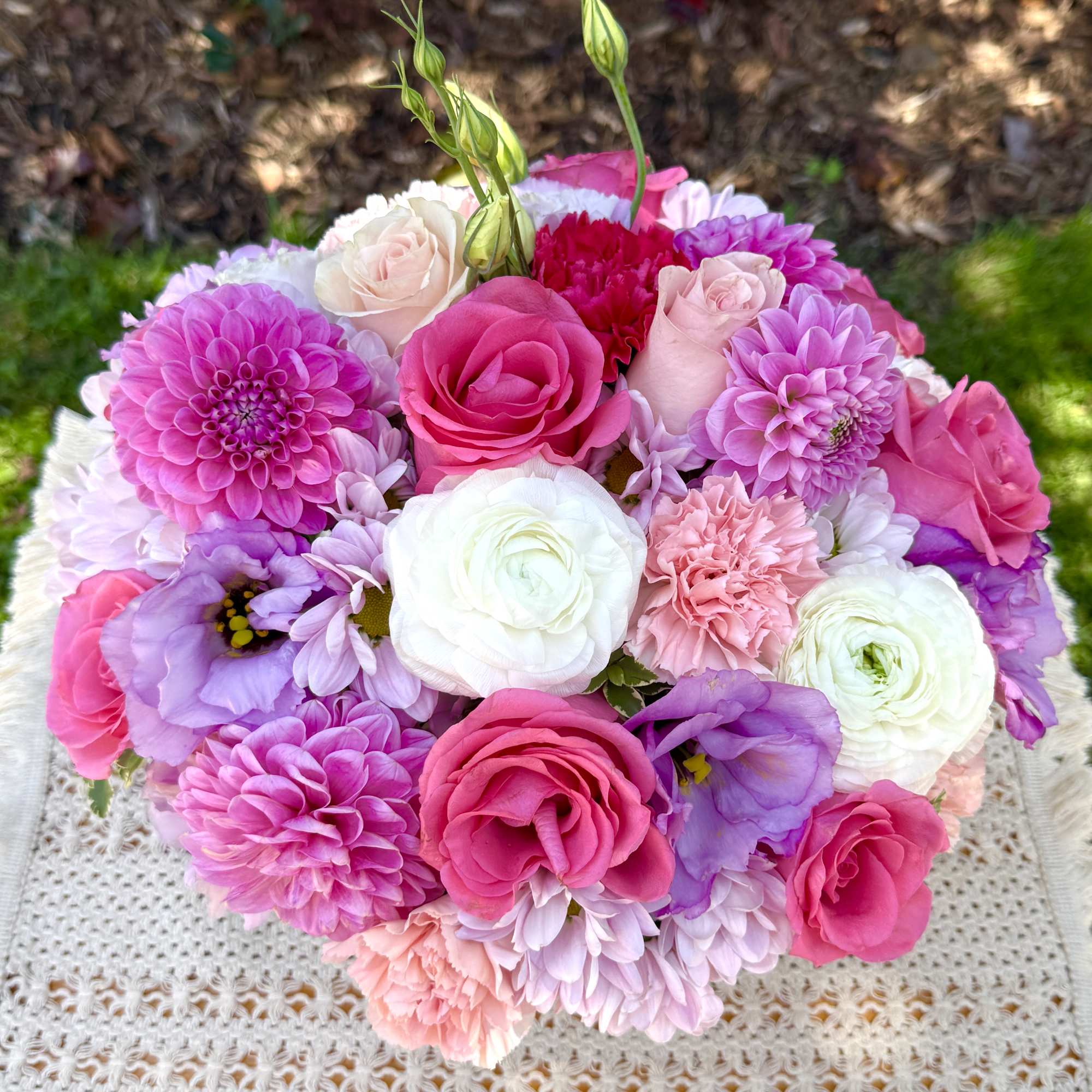Round bouquet of pink, white, and lavender flowers
