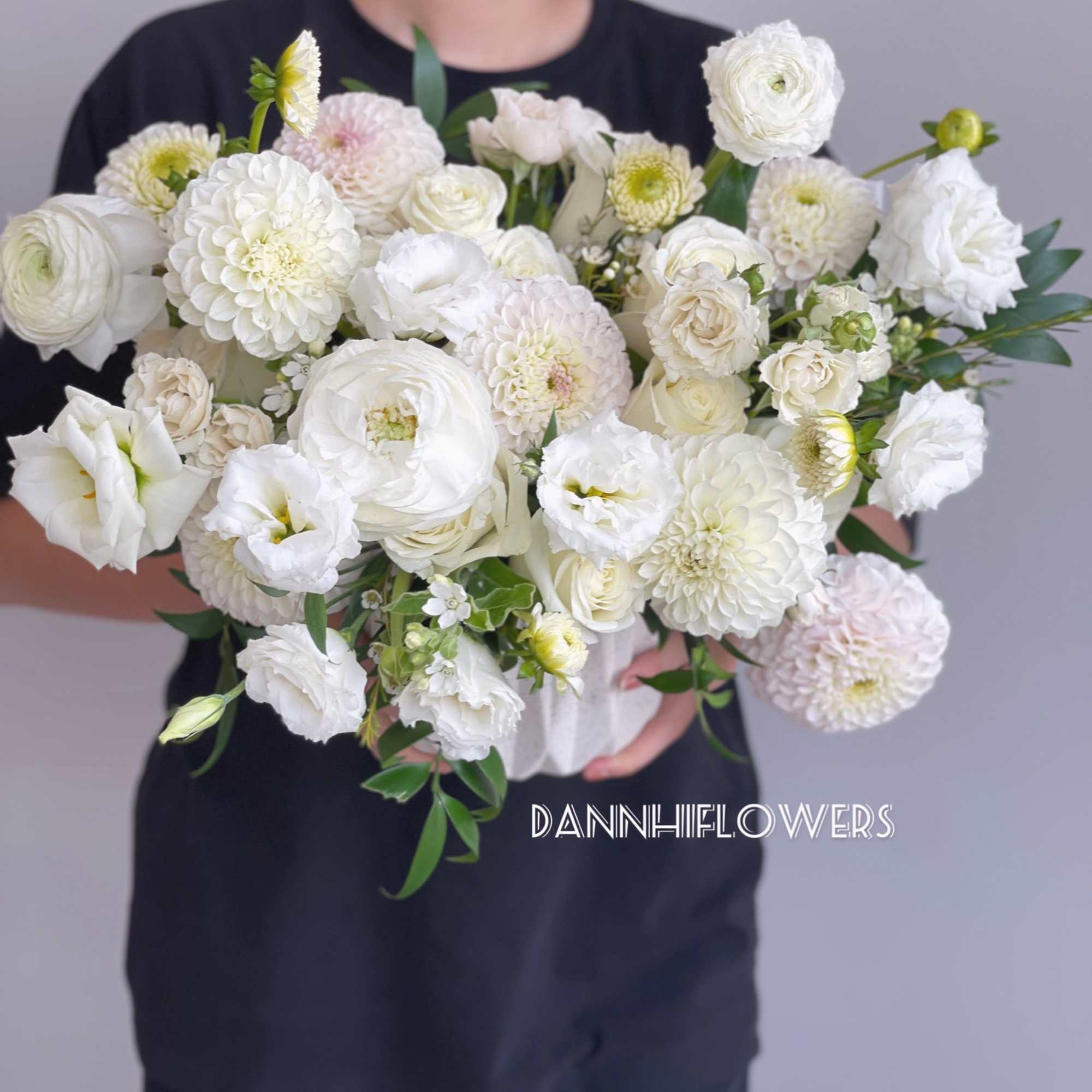 A seasonal mix of white dahlias and white roses, lisianthus in a