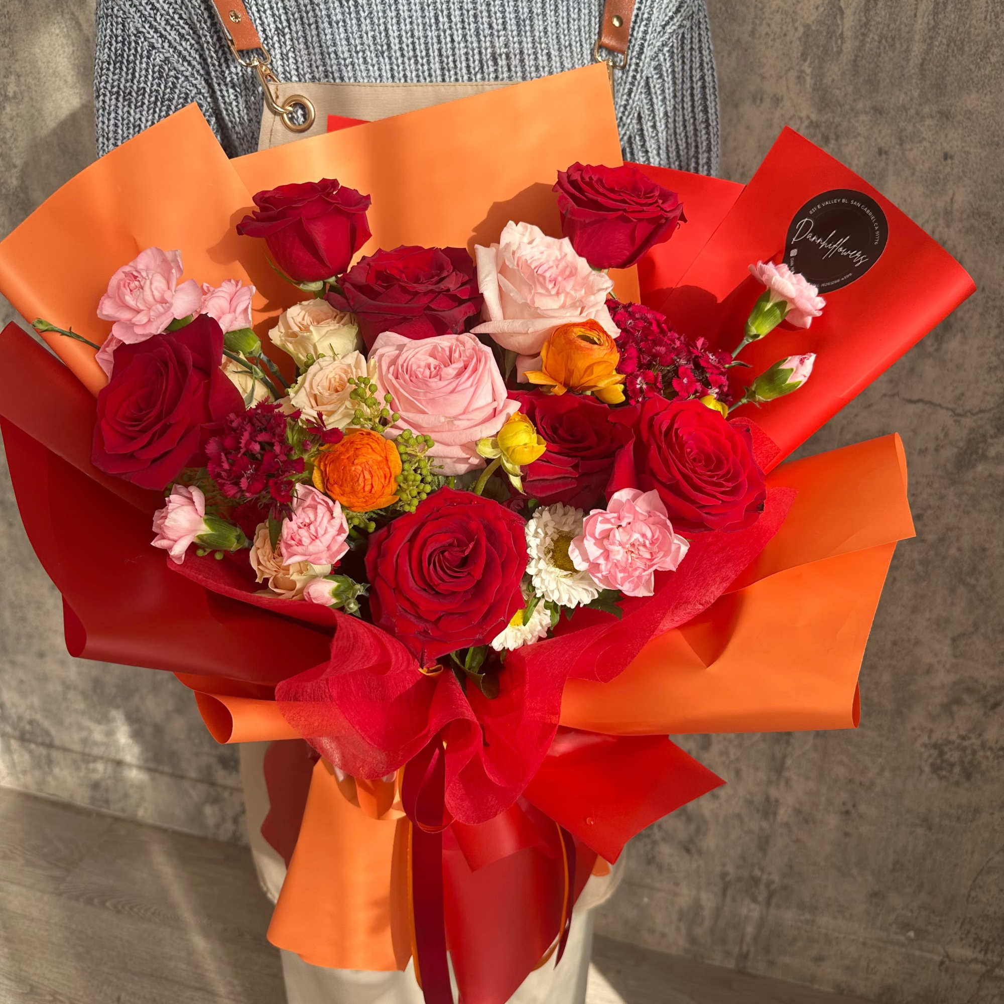 The vibrant bouquet captures the warmth and brilliance of a sunset, making