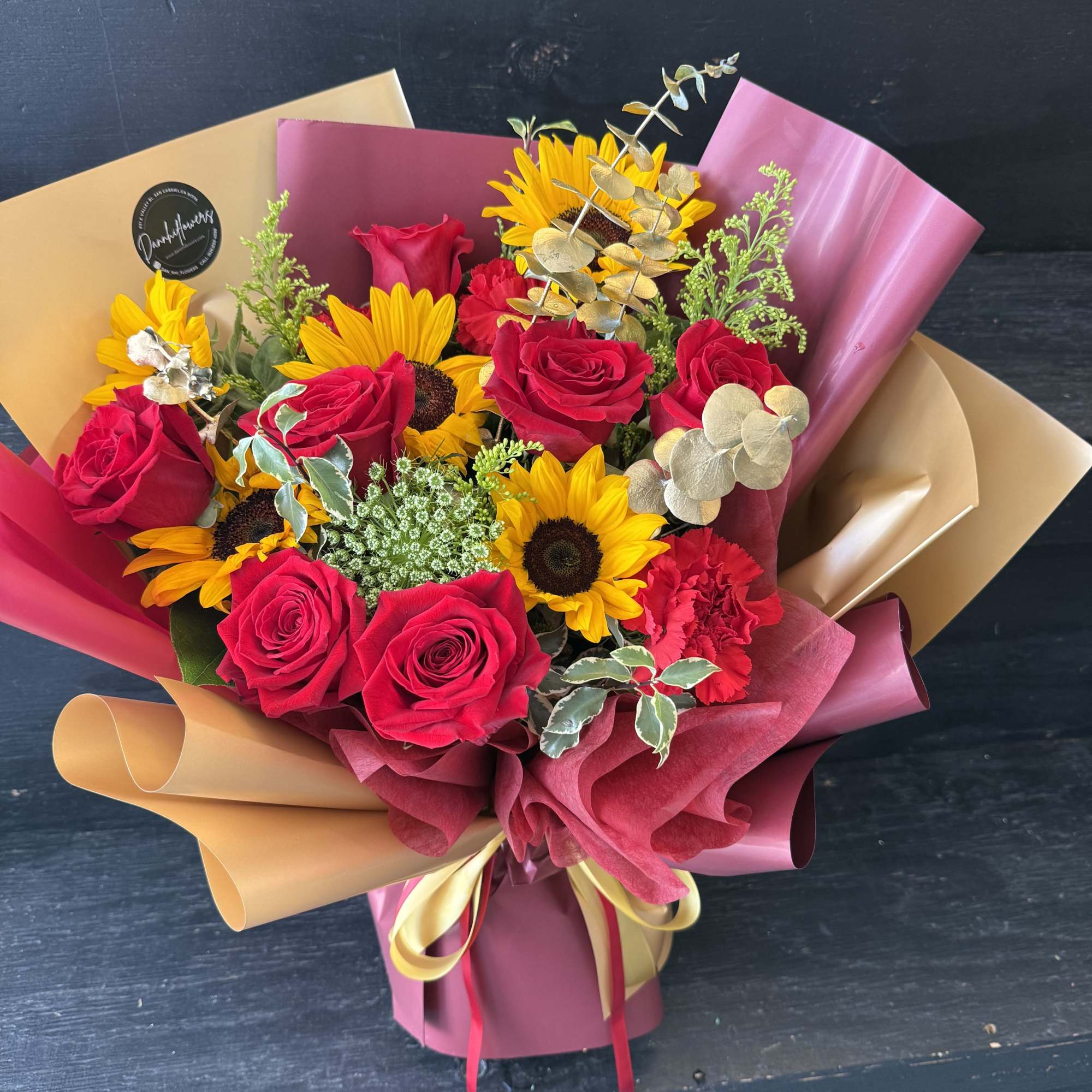 A bold graduation bouquet inspired by cardinal red and gold &mdash; featuring