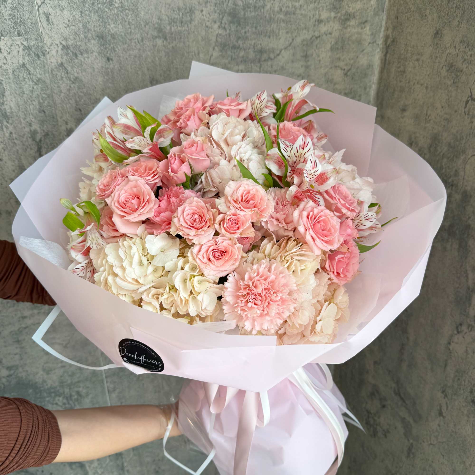Additional flowers will be added to enhance the bouquet size. 