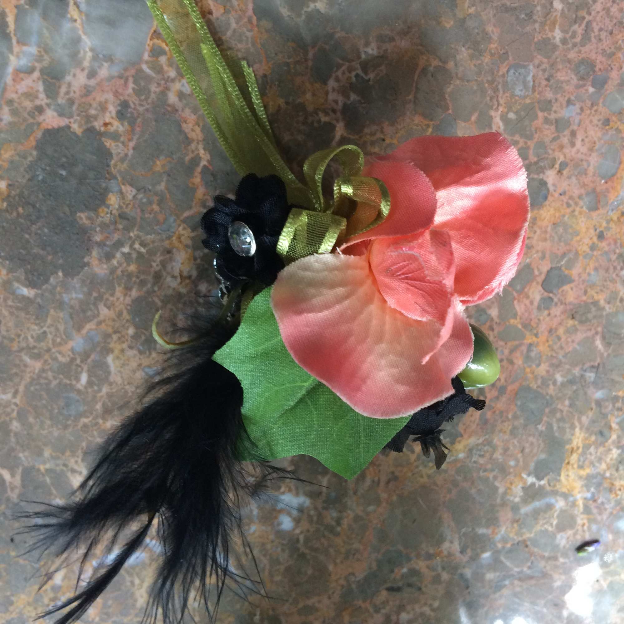 Small corsage with pink silk flowers and black feathers