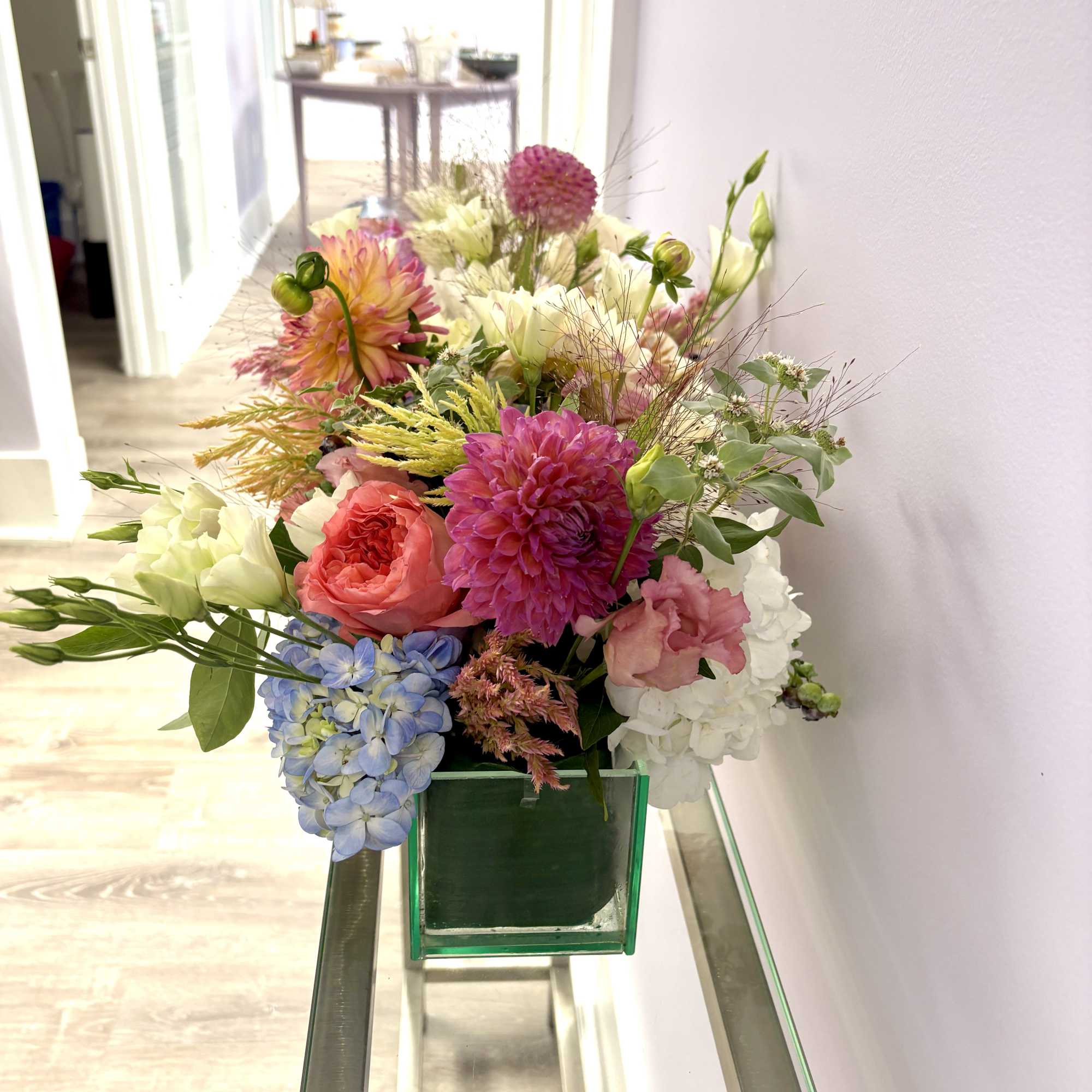 Colorful mixed bouquet in a green glass vase