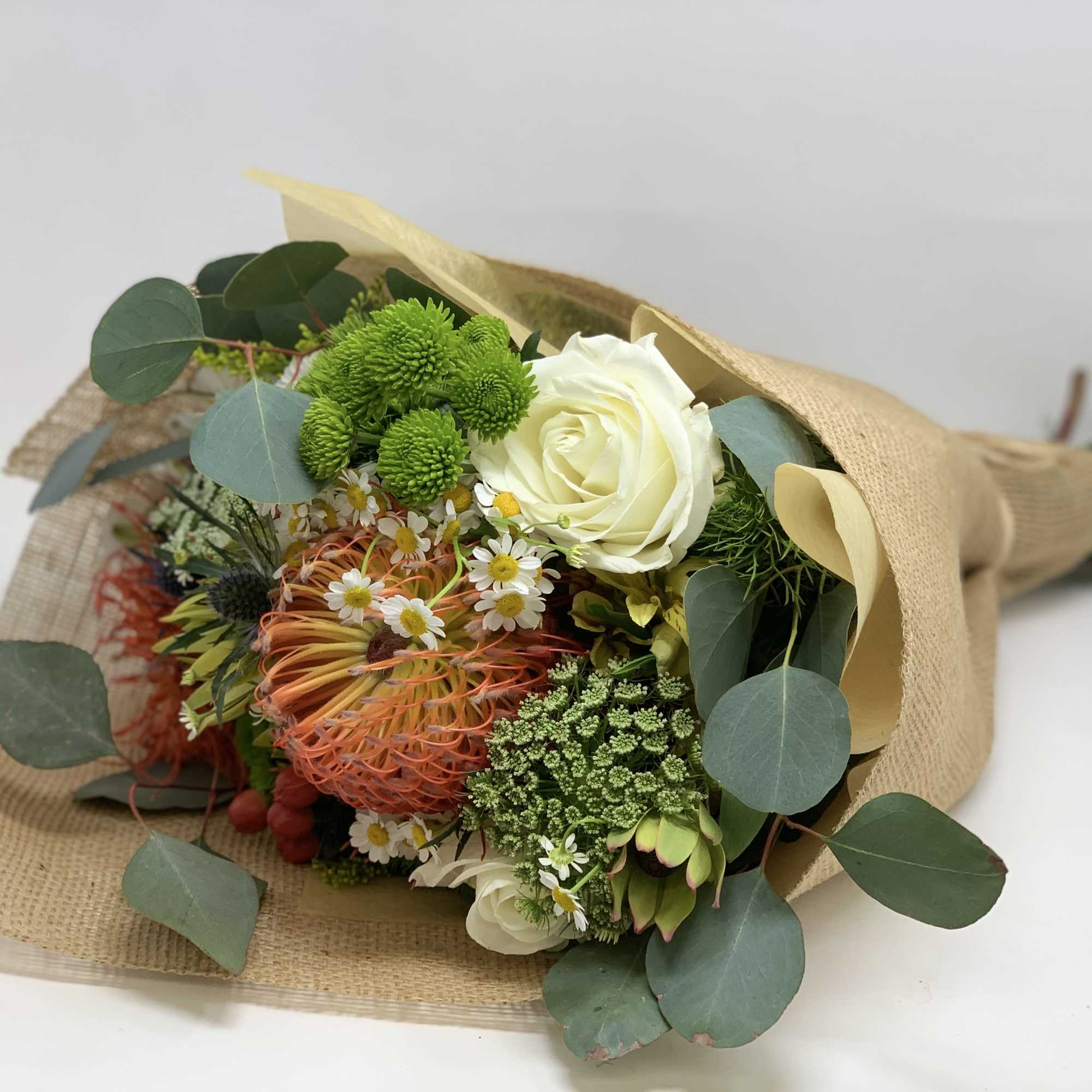 Seasonal flowers arranged into a rustic bouquet. , photo 2 of 3