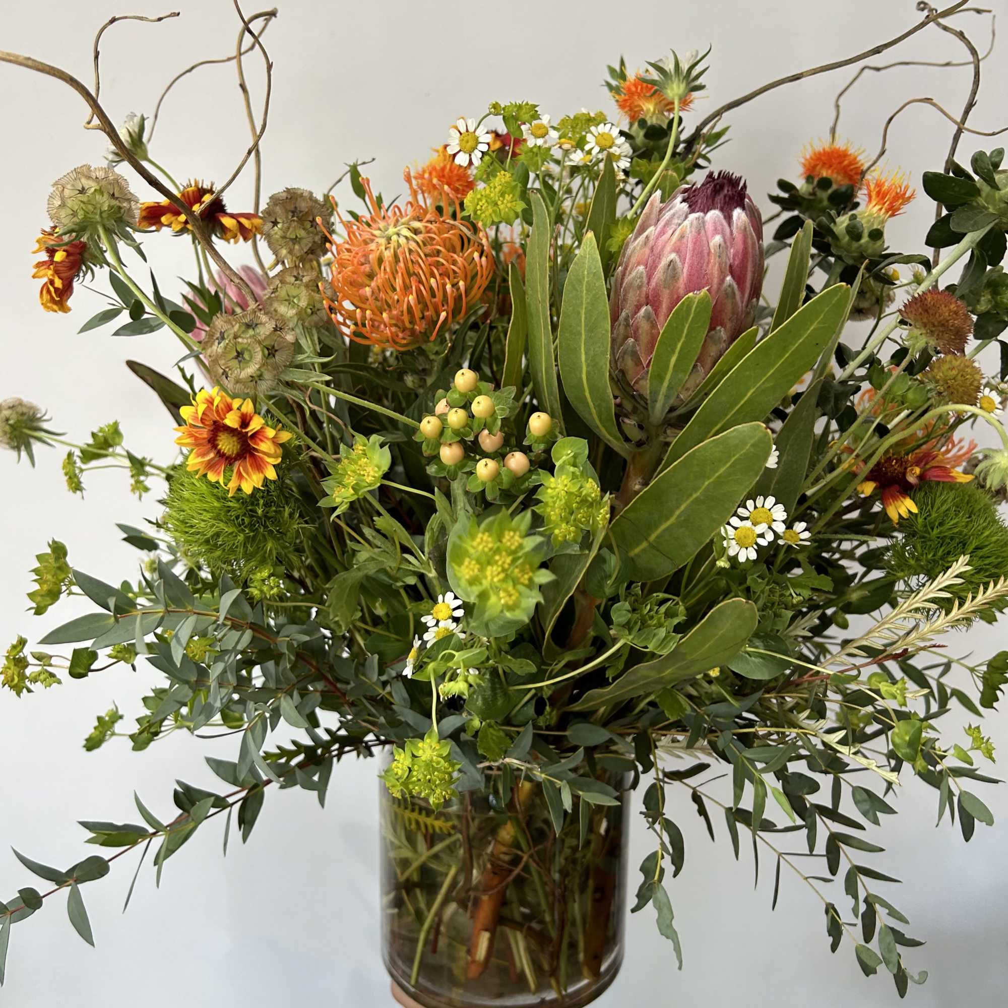 Seasonal native rustic flowers arranged into a vase with fillers and greens., photo 2 of 2