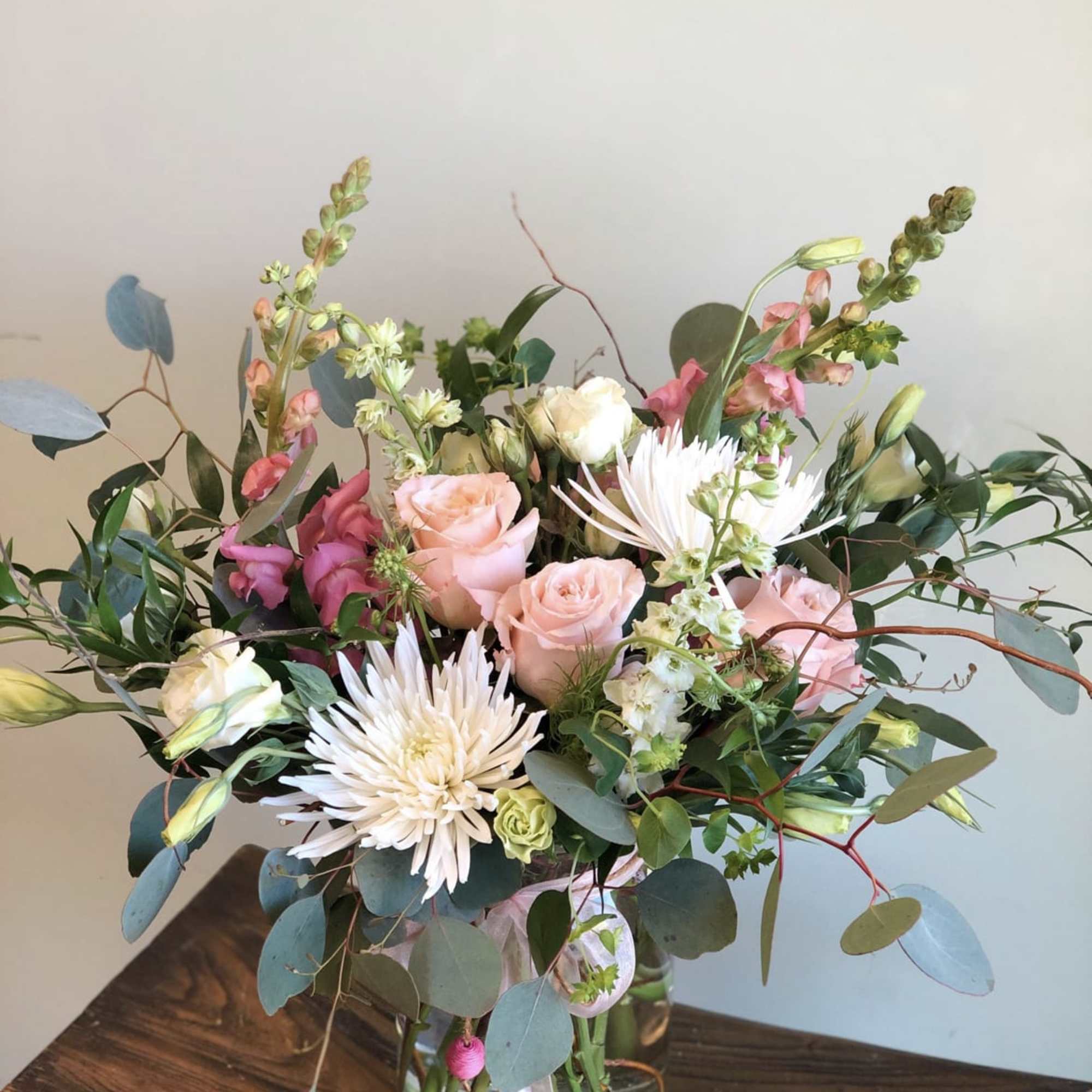 Pink roses and white spider mums in a glass vase