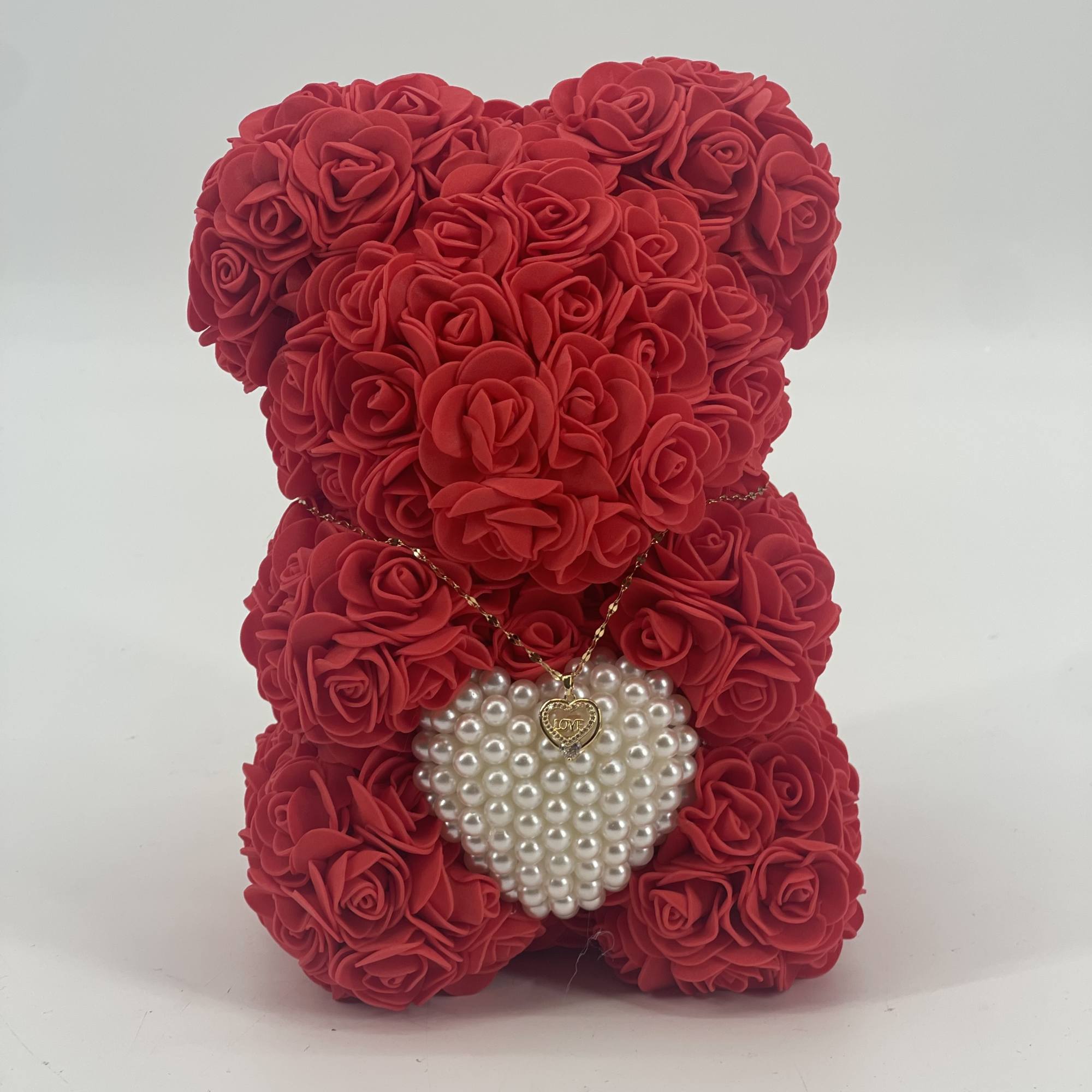 Red rose teddy bear with a pearl heart pendant