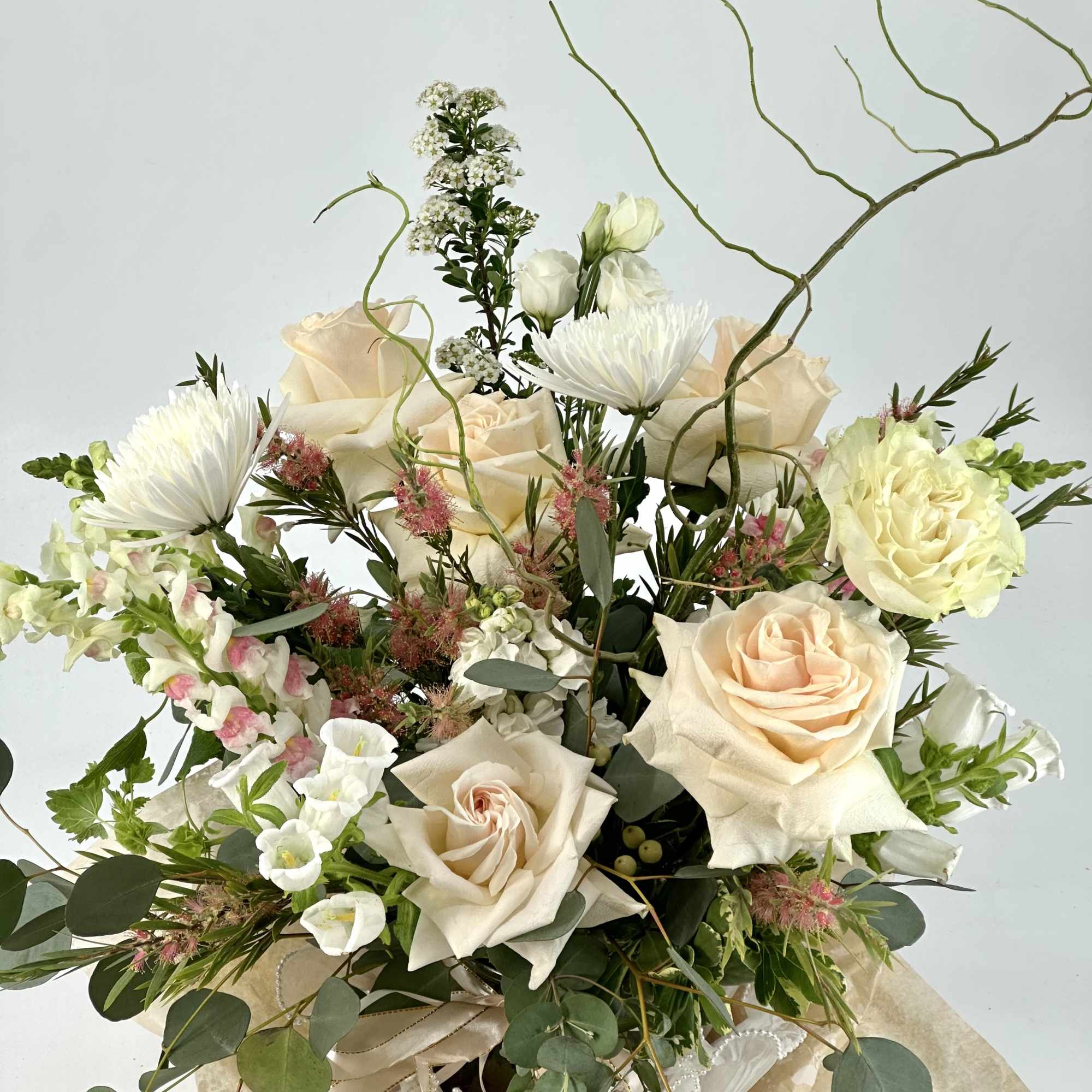 Bouquet of cream roses and white blooms with airy greenery