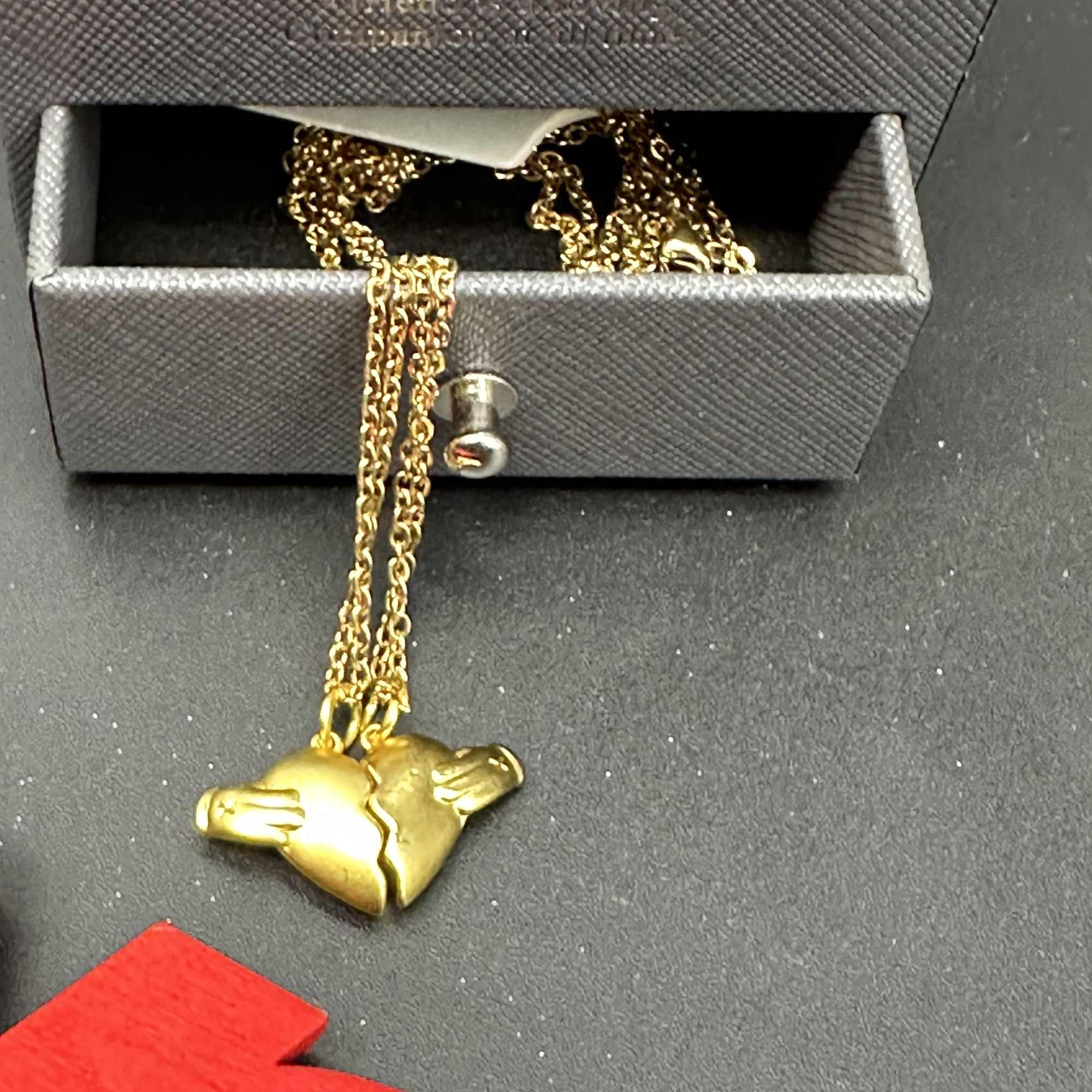 Gold heart pendant necklace in a jewelry box