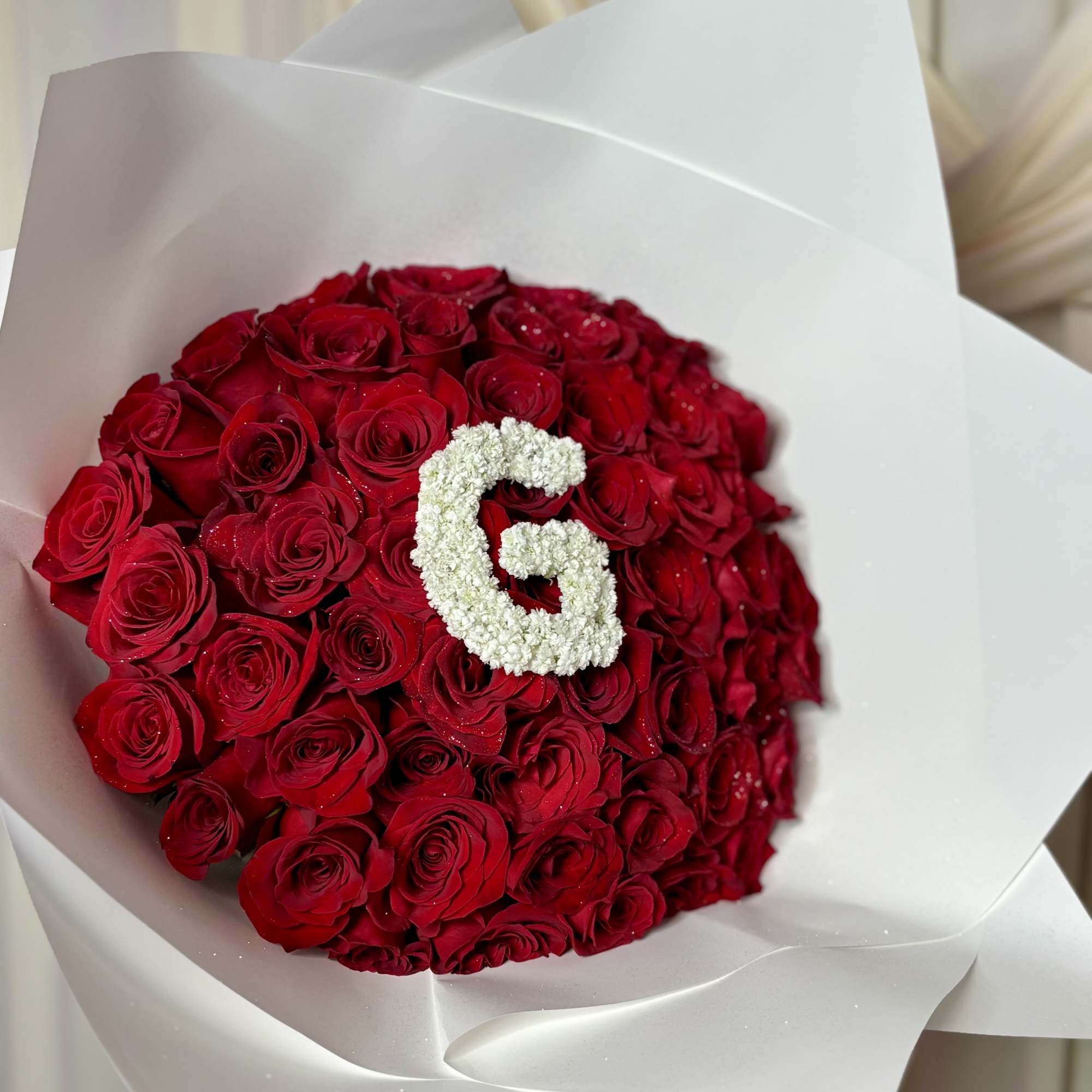 A luxurious statement bouquet featuring premium red roses beautifully wrapped in our