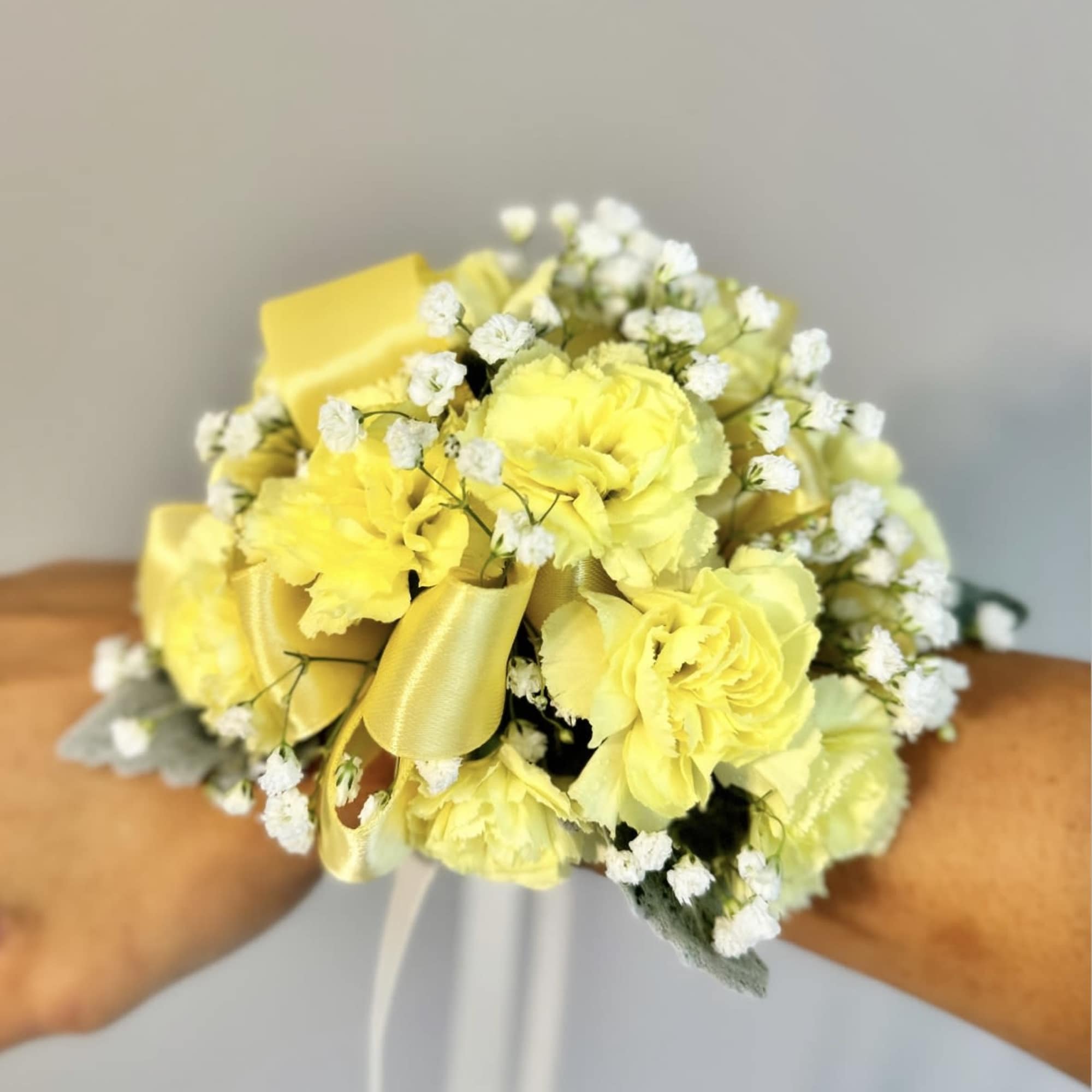 Yellow carnation bouquet with white baby's breath and satin ribbon