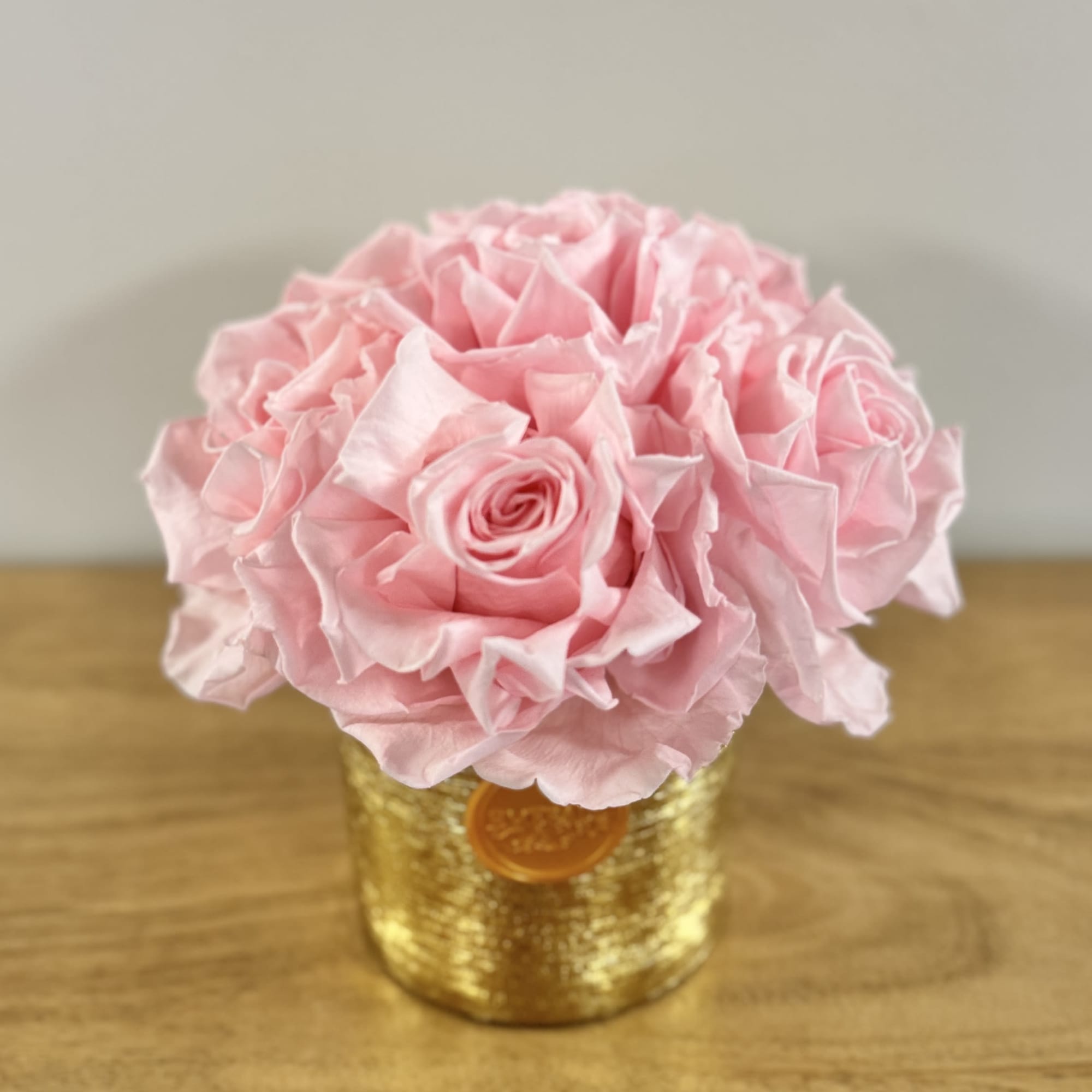 Pink rose bouquet in a gold textured container